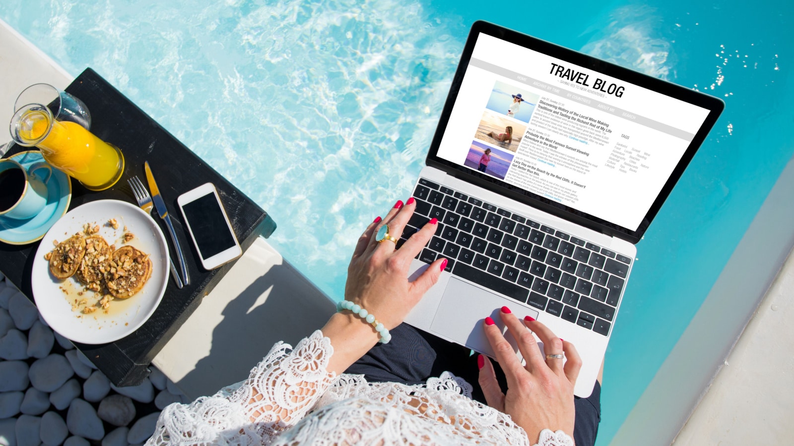 Woman working on her travel blog outdoors by the pool