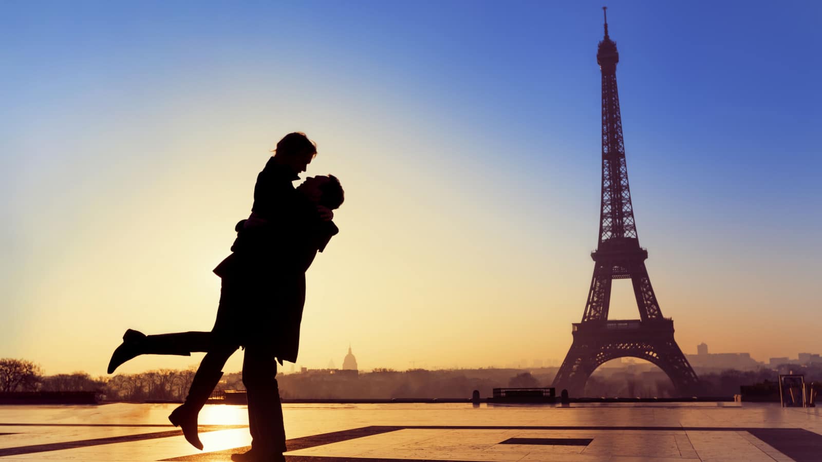 Couple kissing under the eiffel tower