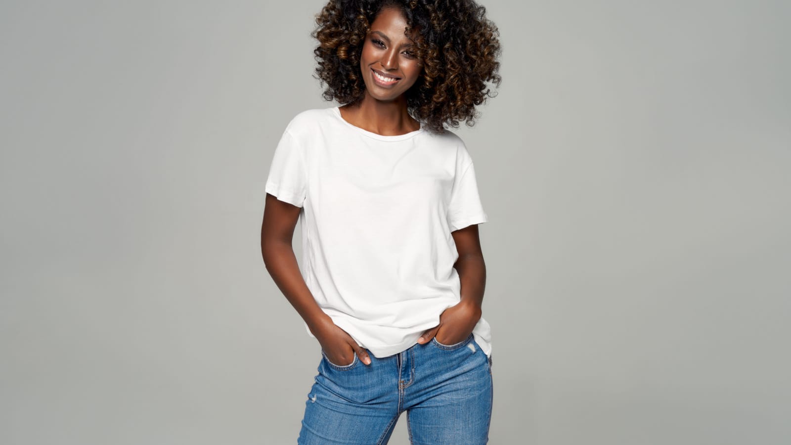 Sexy black woman with afro hair wear classic outfit isolated on gray background