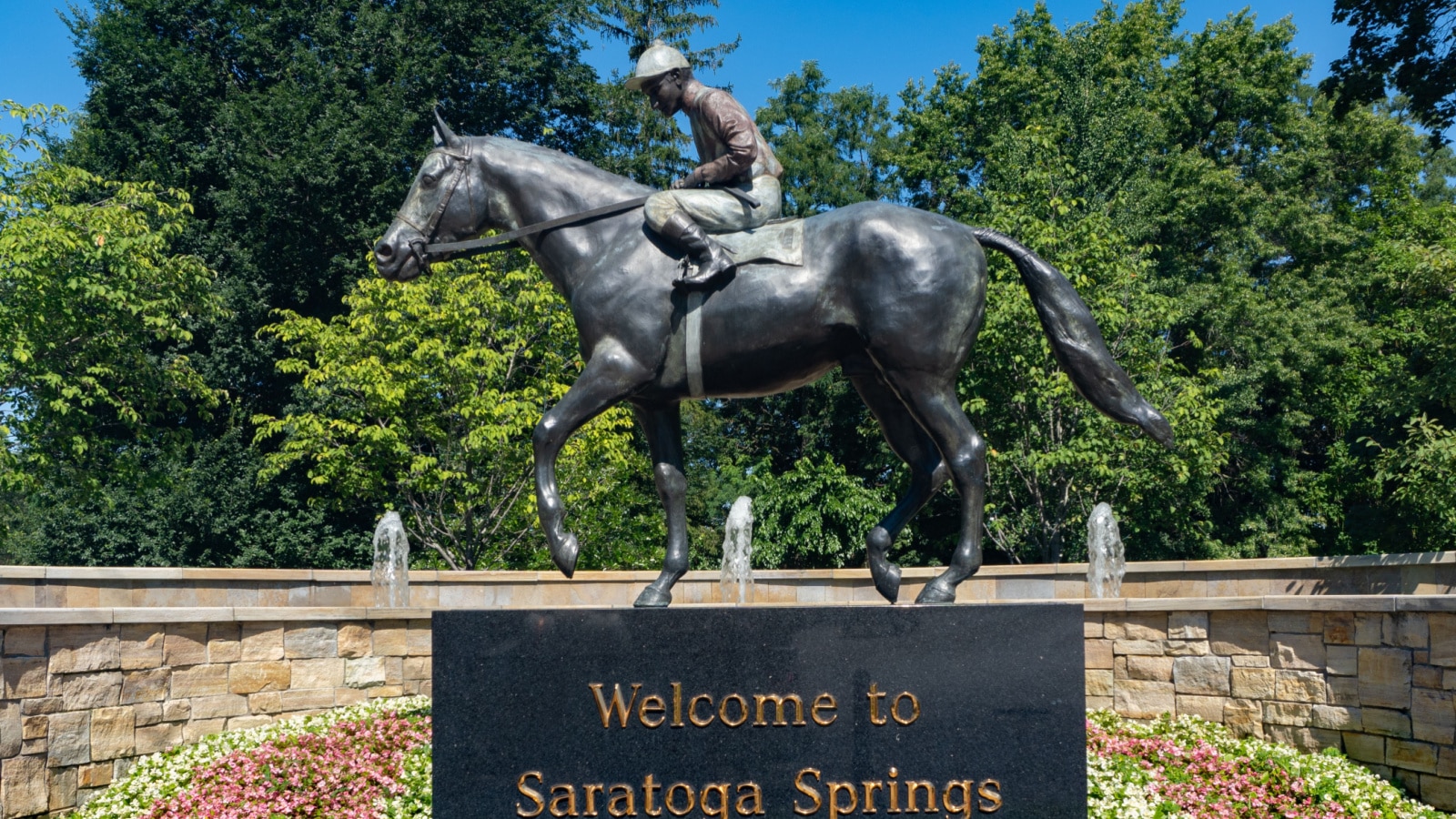 Saratoga Springs, NY, USA - July 29, 2020: "Welcome To Saratoga Springs" statue of jockey riding horse.