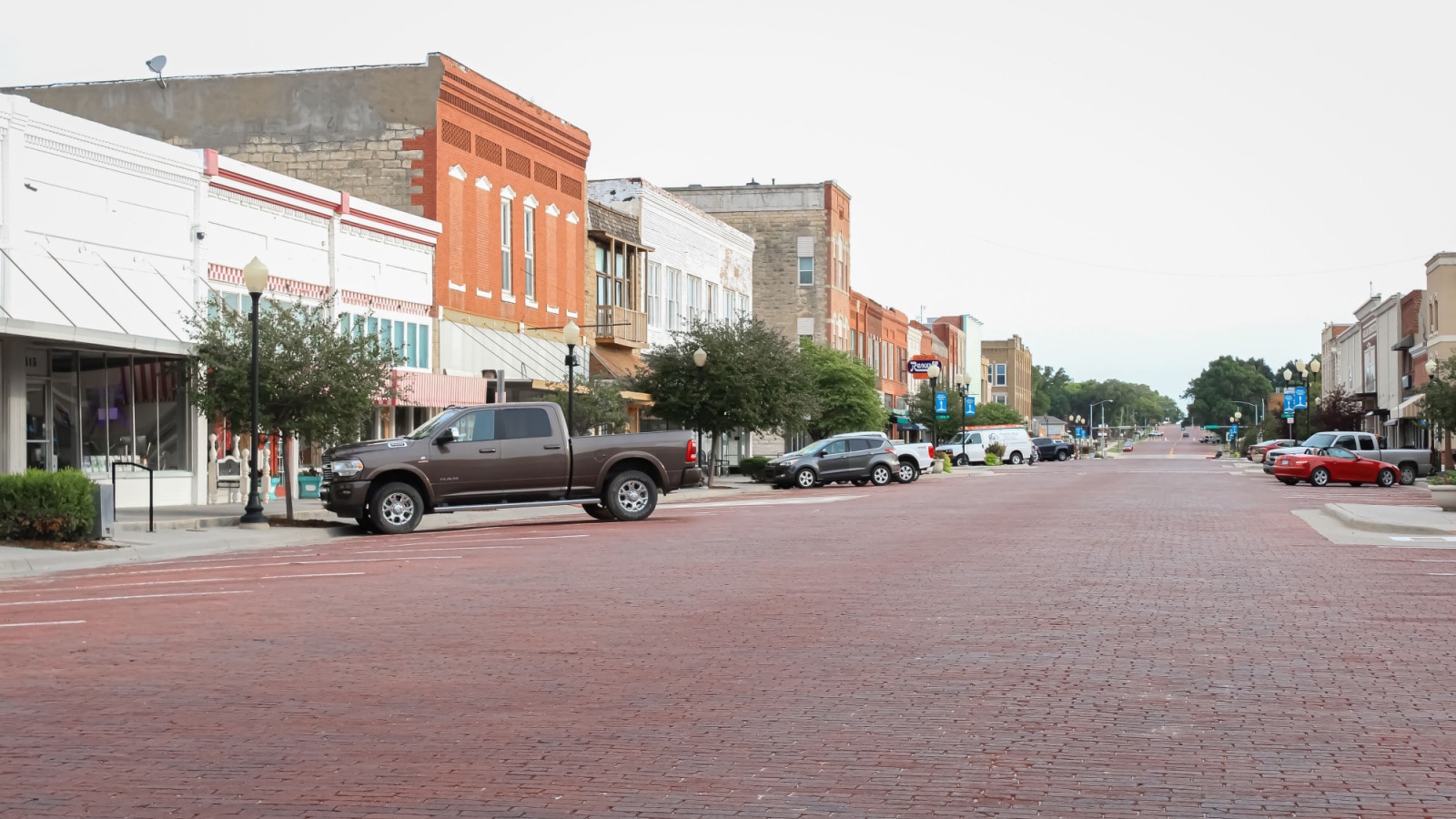 Augusta, Kansas United States - August 16 2021: a view of the main street in the morning with a truck parked in front of a store