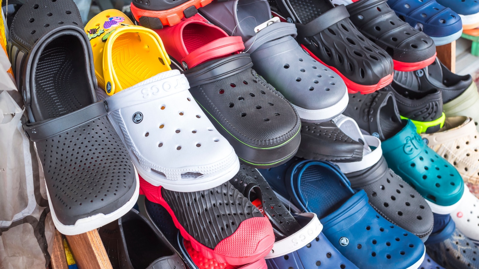 Metro Manila, Philippines - Nov 2021: Counterfeit and knockoff Crocs foam clogs of different designs on display for sale at a local market.