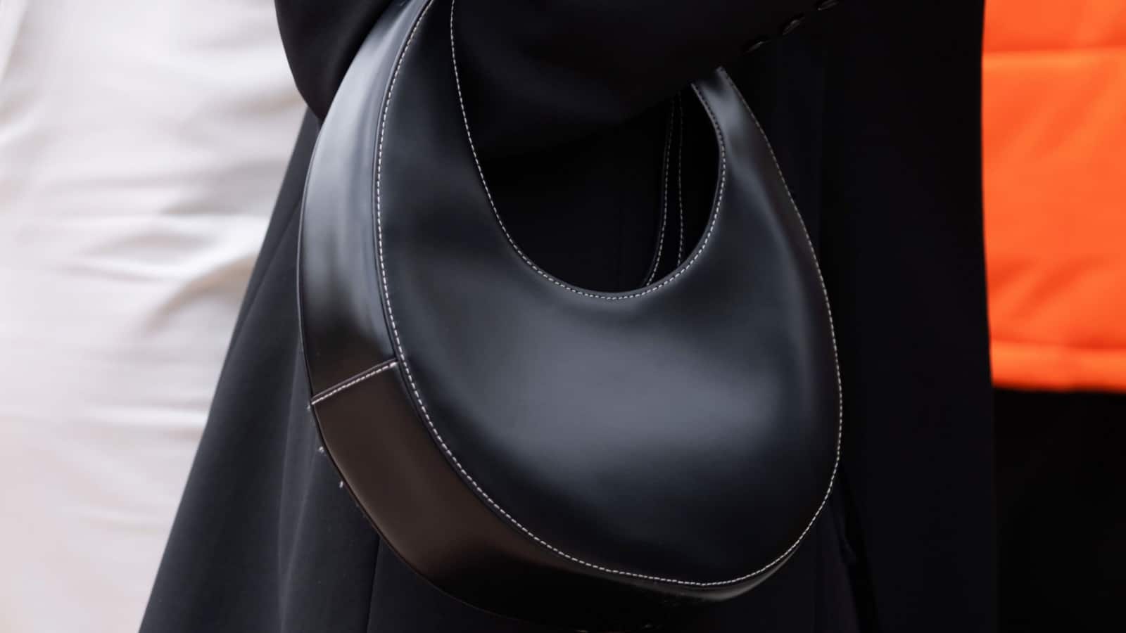 Milan, Italy - September, 21, 2022: woman wears black leather staud mini moon handbag, street style outfit details