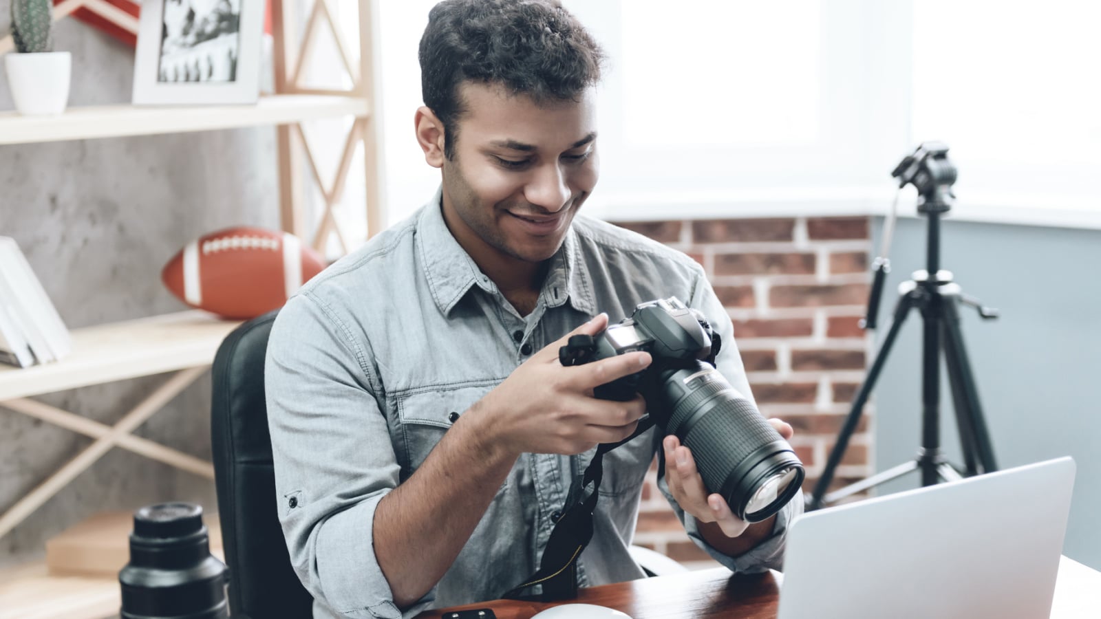 Indian Happy Young Man Photographer Work from Home Using Technology Editing Photo with Laptop. Creative Male Hipster in Casual Wear Focusing on Freelance Work. Business People Concept.
