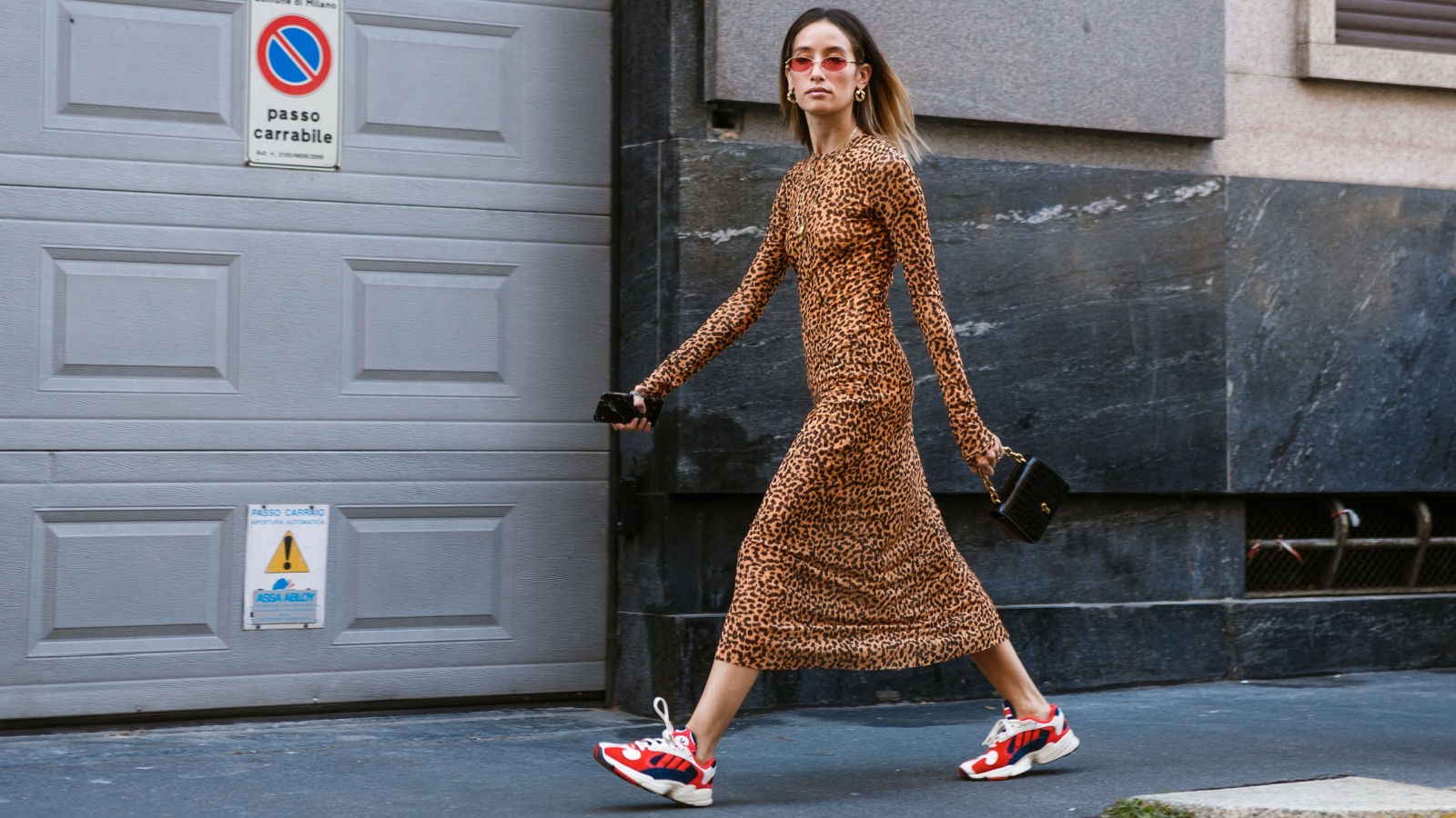 MILAN, ITALY - SEPTEMBER 21, 2018: A guest wearing Adidas sneakers and animal print dress seen outside BLIMARINE show during Milan Fashion Week Spring/Summer 2019.