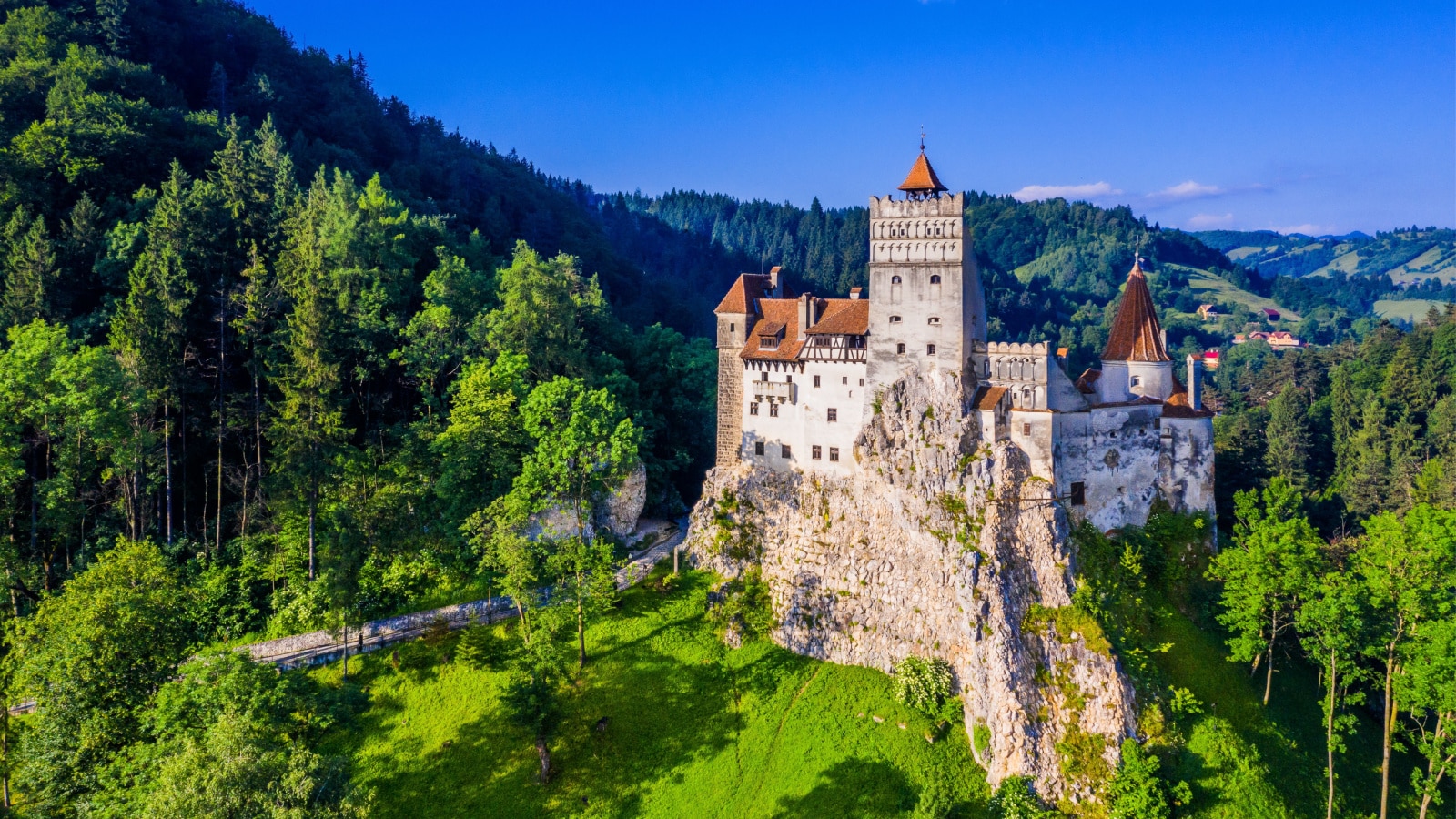 A stunning aerial landscape image of the medieval Castle of Bran, known for the myth of Dracula, located in Brasov, Transylvania. Romania.