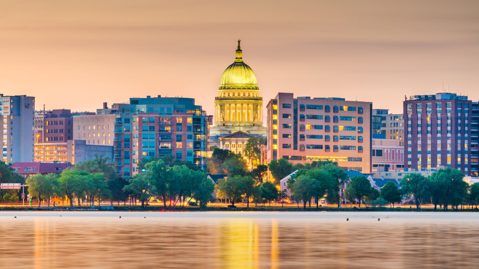 Madison, Wisconsin, USA downtown skyline at dusk on Lake Monona.