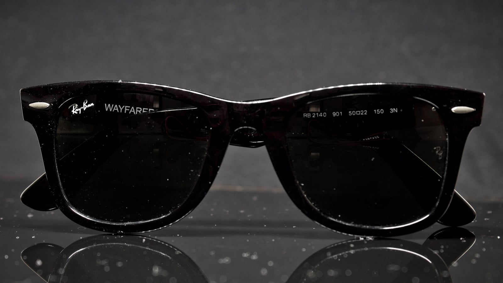 Picture of a Ray-Ban wayfarer under some dust;