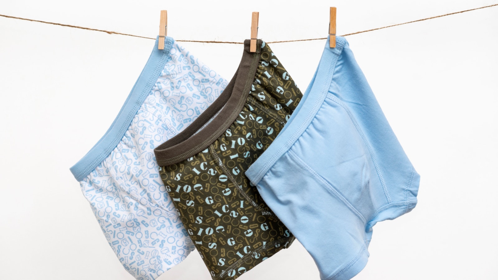Male (boy) brief boxers hanging on the clothesline isolated on a white background
