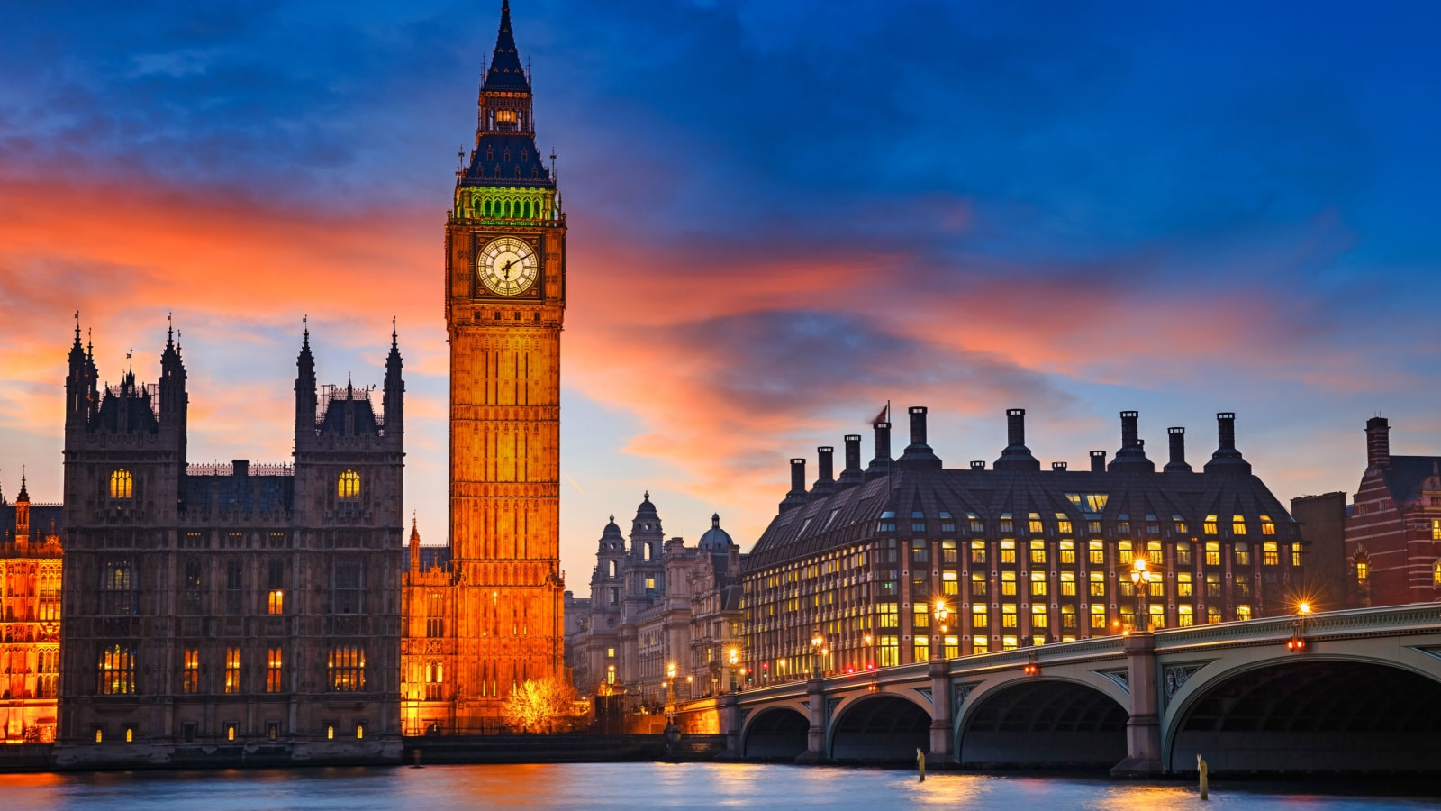 A stunning landscape image of Big Ben and Westminster bridge at dusk in London.