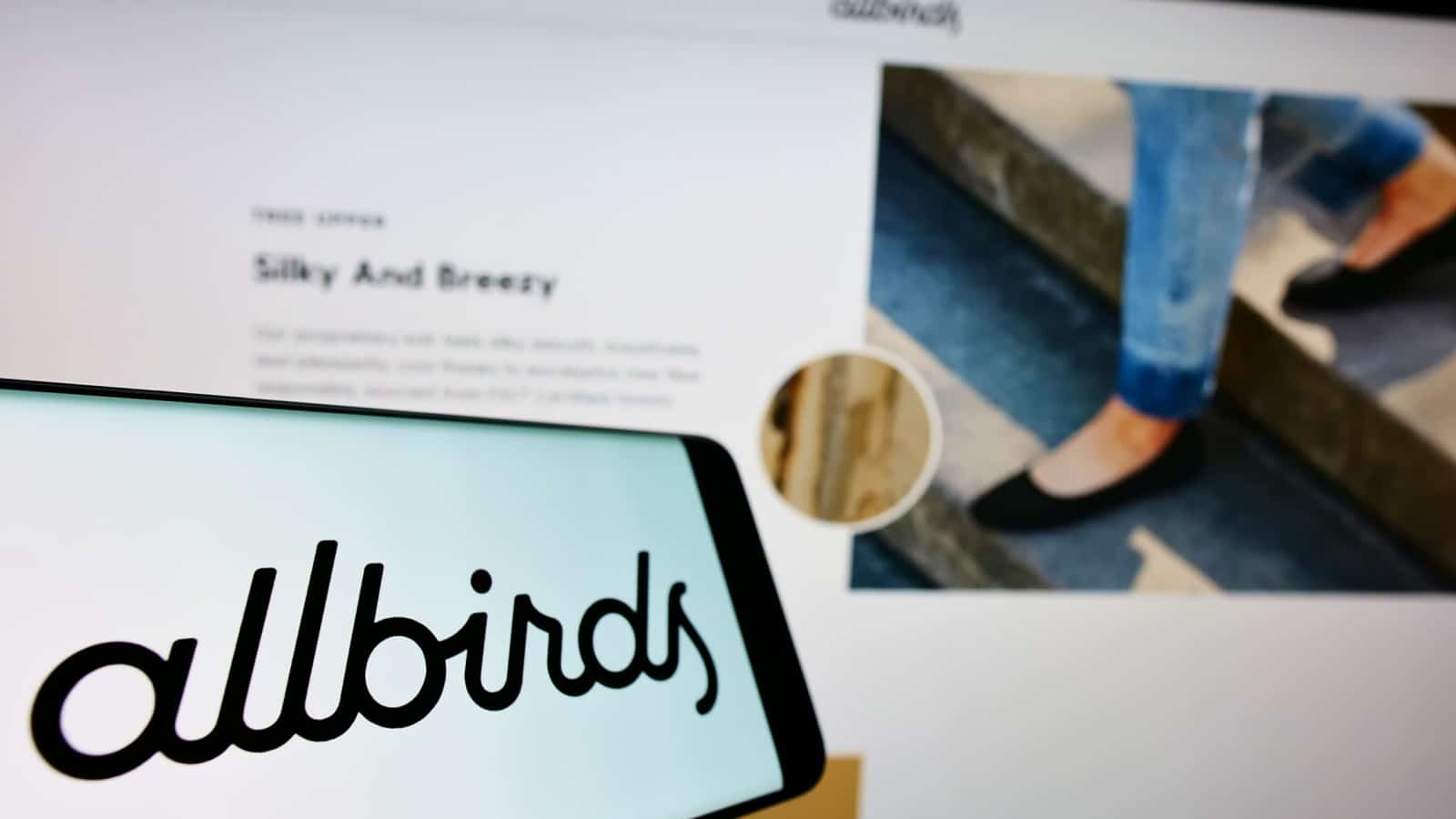 STUTTGART, GERMANY - Sep 06, 2021: Smartphone with logo of footwear company Allbirds Inc on screen in front of business website Focus on center-left of phone display