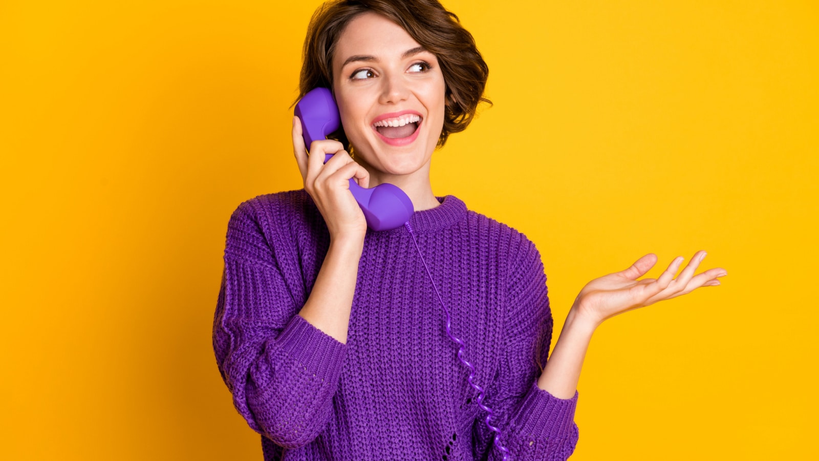 Photo portrait of woman talking on landline phone isolated on vivid yellow colored background