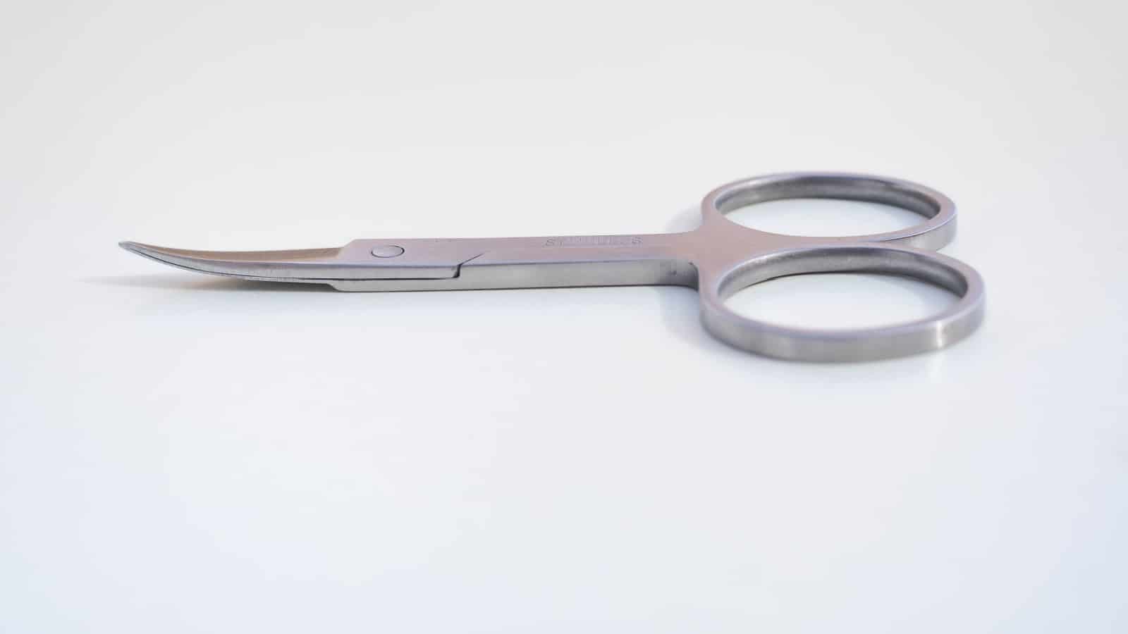 a small pair of scissors, nail scissors on white background