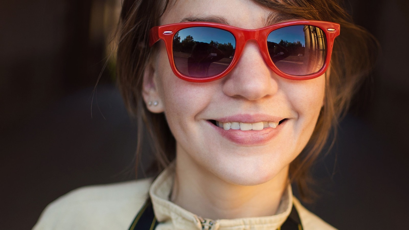 The girl in red sunglasses smiling