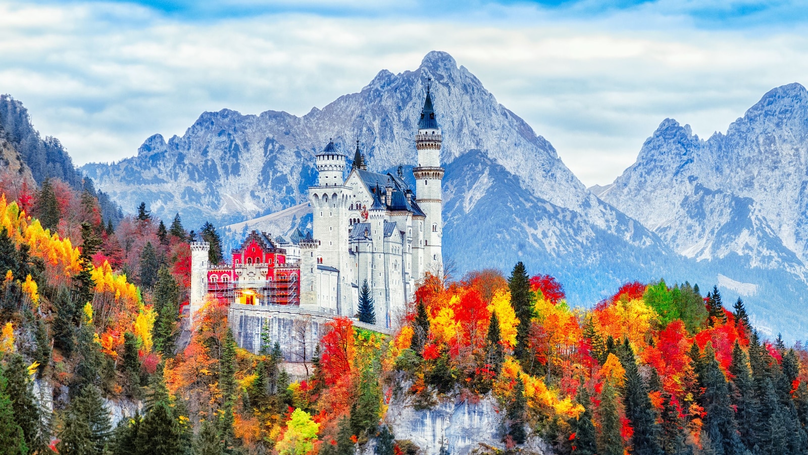 Neuschwanstein Castle Neuschwanstein medieval castle in Germany, Bavaria land. Beautiful autumn scenery of Neuschwanstein ancient castle circled by colorful tree, amazing seasonal fall scene. Famous and popular landmark.