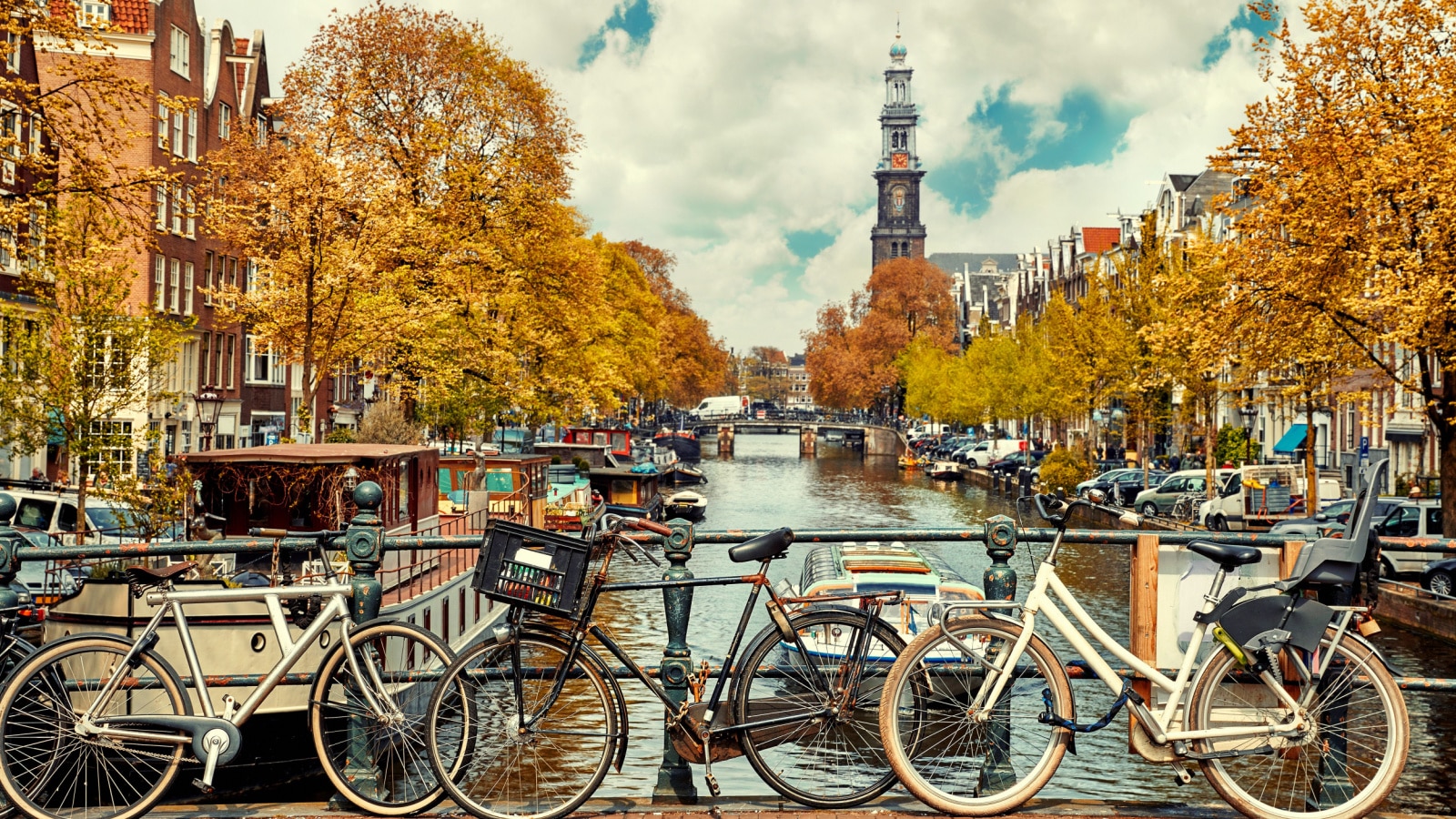 Bike over canal Amsterdam city. Picturesque town landscape in Netherlands with view on river Amstel.