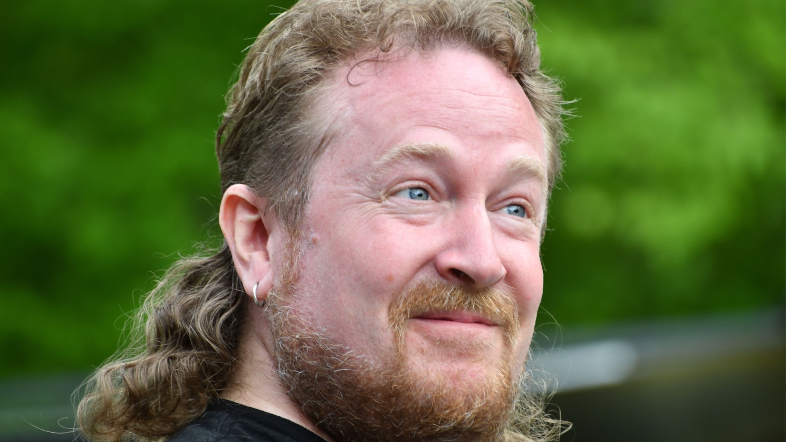 White man with mullet poses for portrait