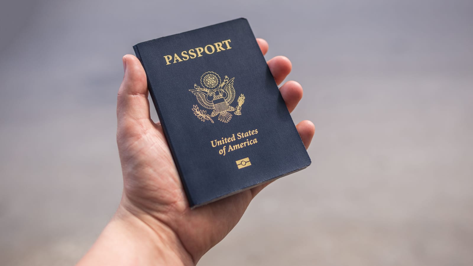 Holding a blue American passport