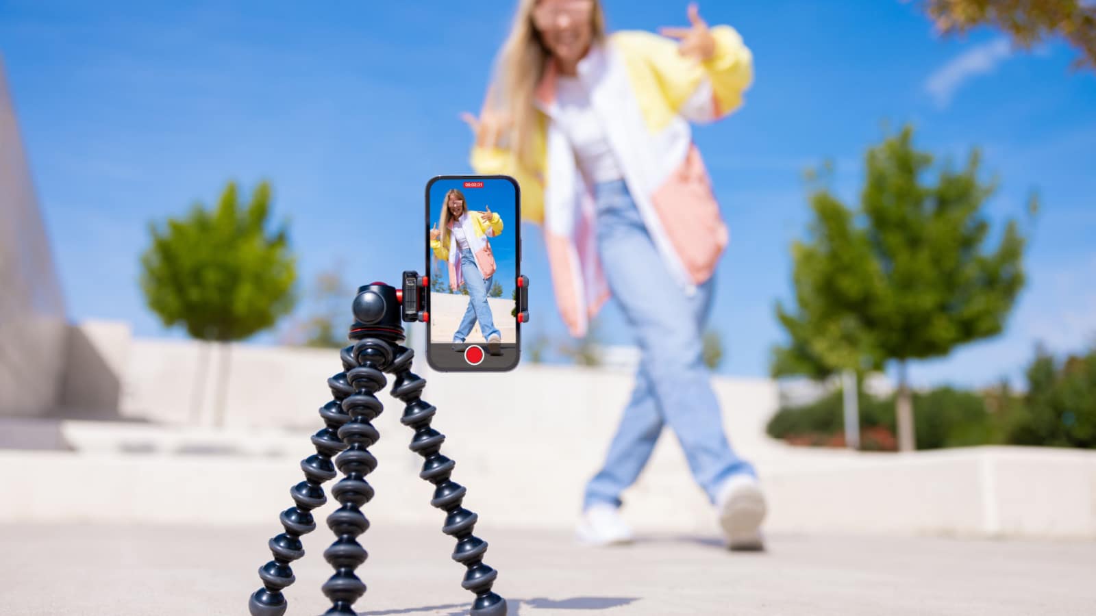 Teenage girl filming video of herself on mobile phone