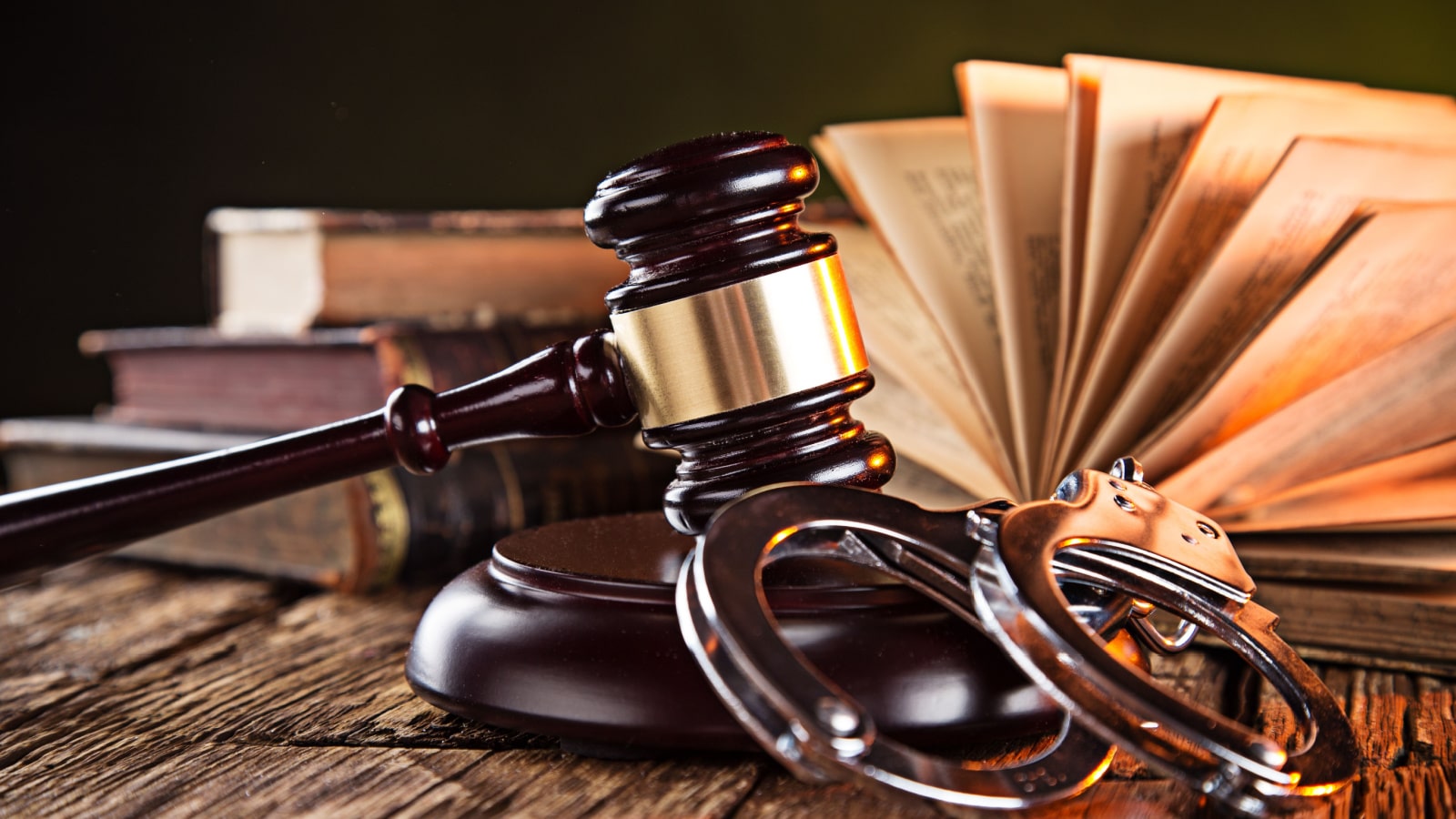 Wooden gavel and books on wooden table, law concept