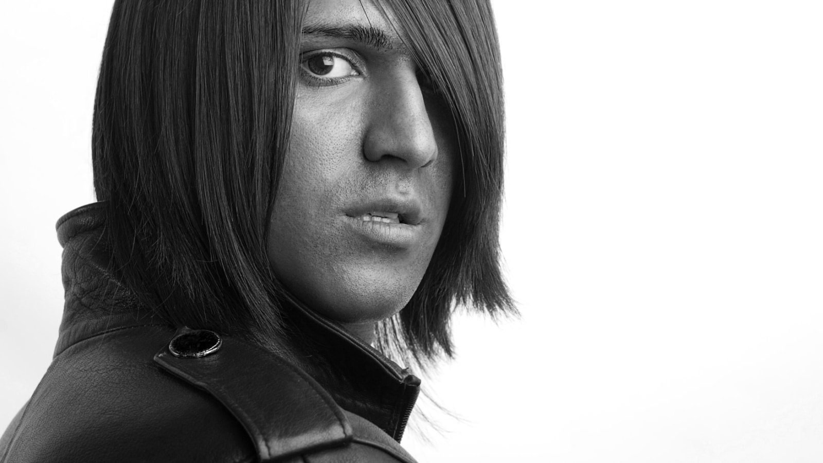 young handsome man with long brunette hair on white background