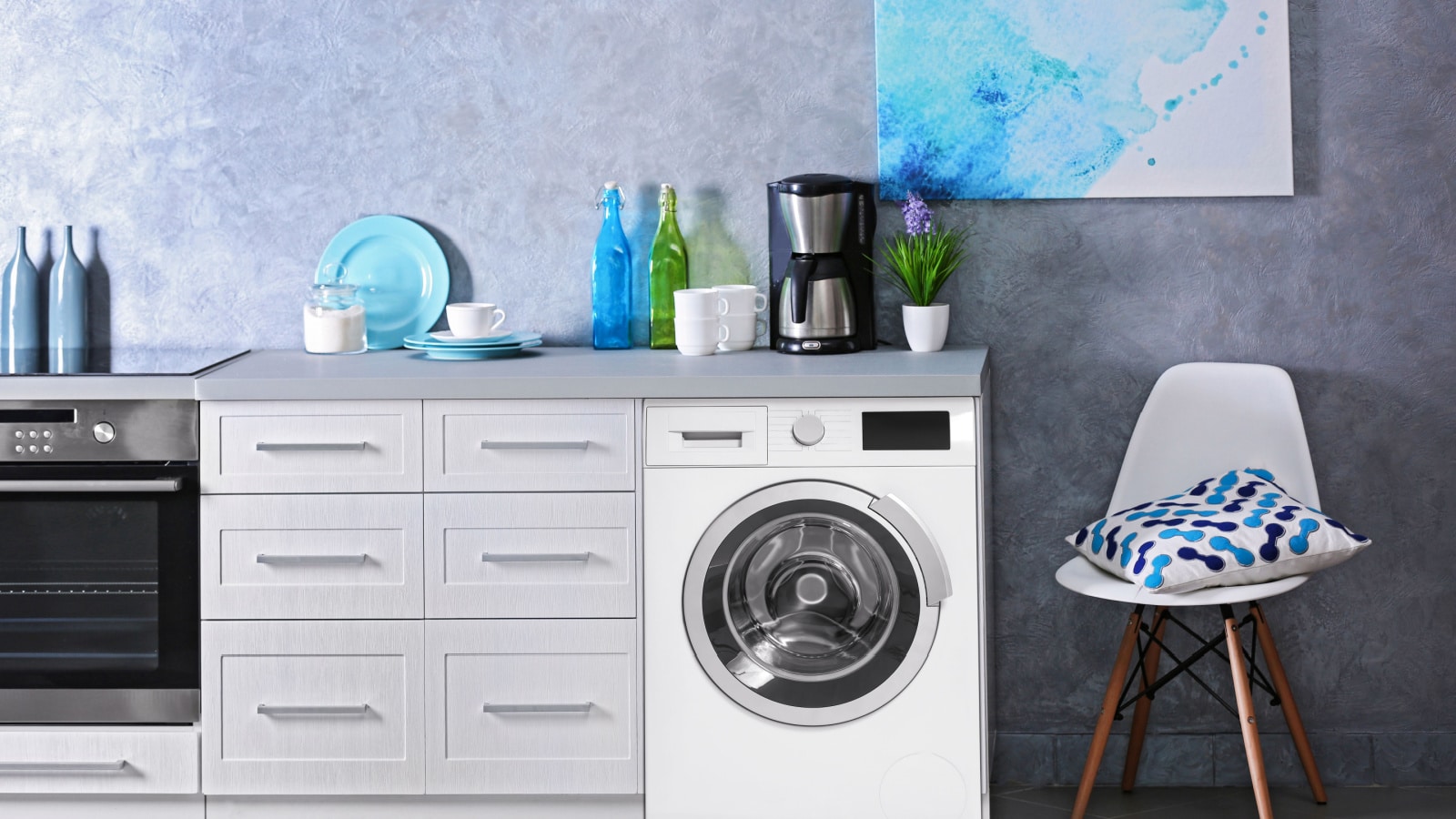 Interior of modern kitchen with washing machine. Laundry day