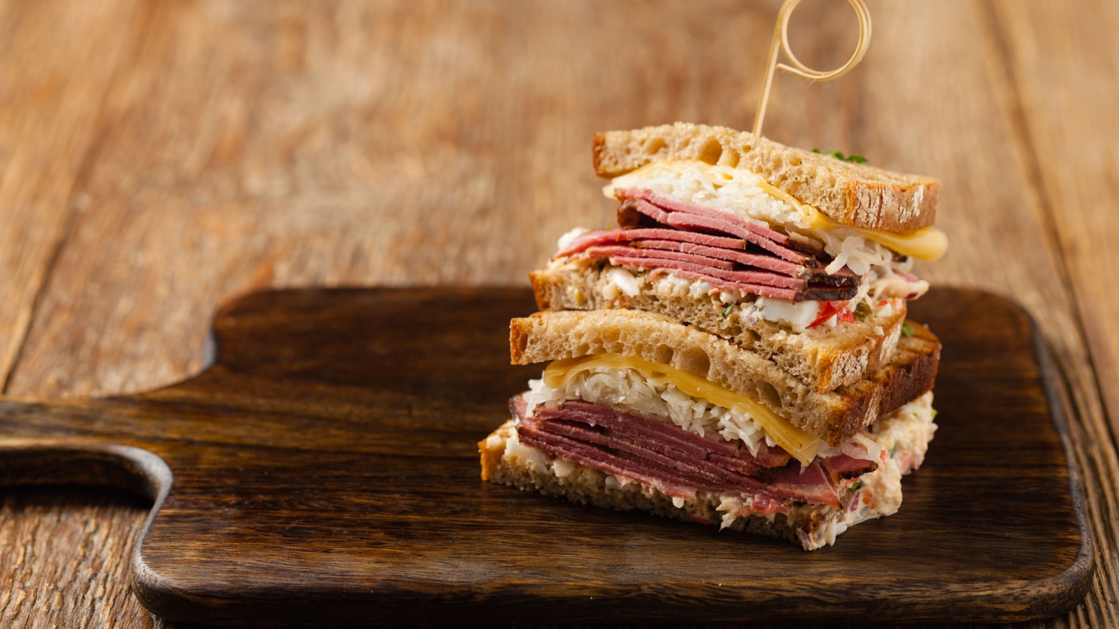 Ruben sandwich. New York sandwich with pastrami, sauce 1000 islands and sauerkraut. Front view. Fast food.