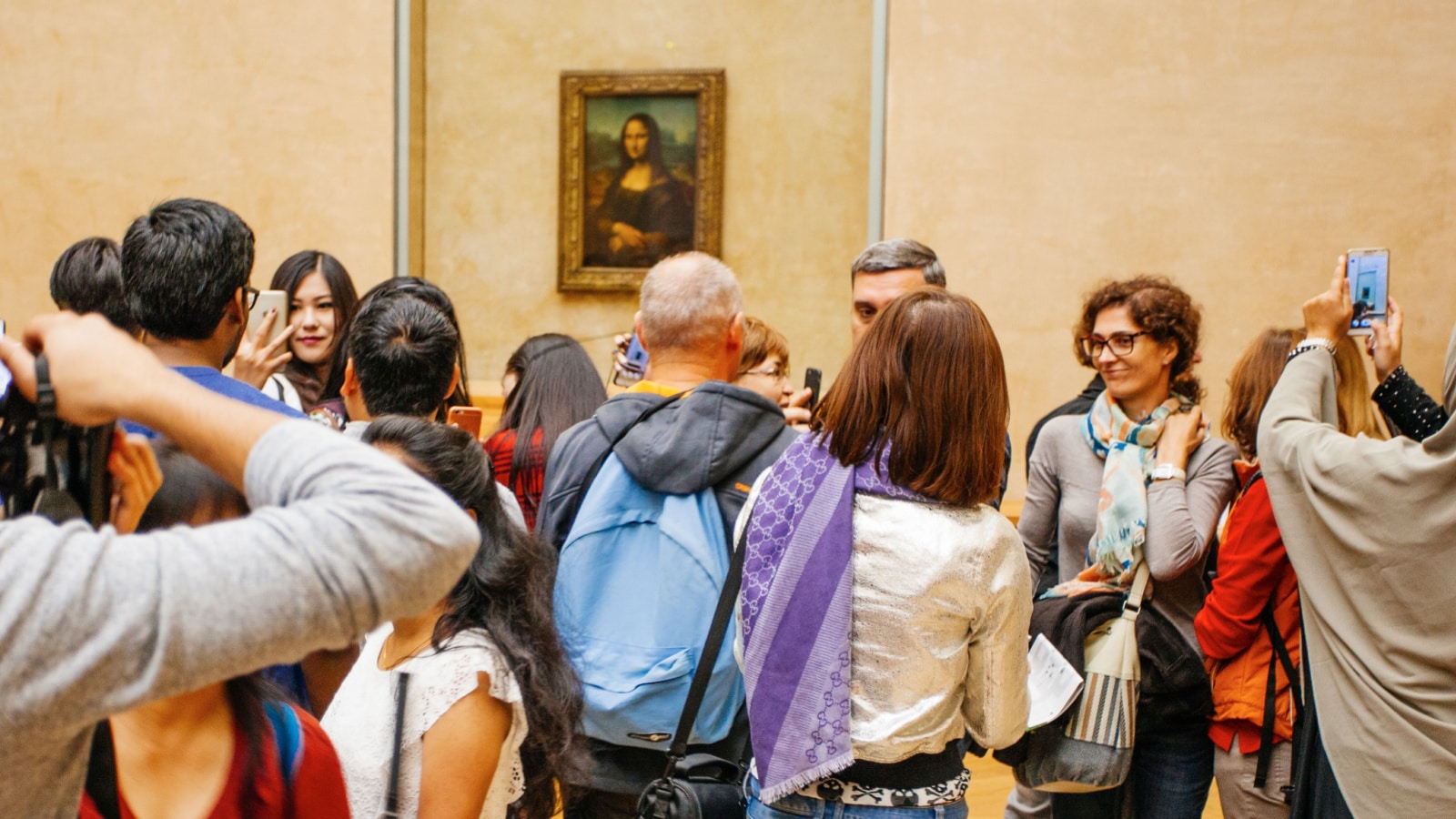 PARIS, FRANCE - October 11, 2016: Visitors take photo of Leonardo DaVinci's "Mona Lisa" at the Louvre Museum