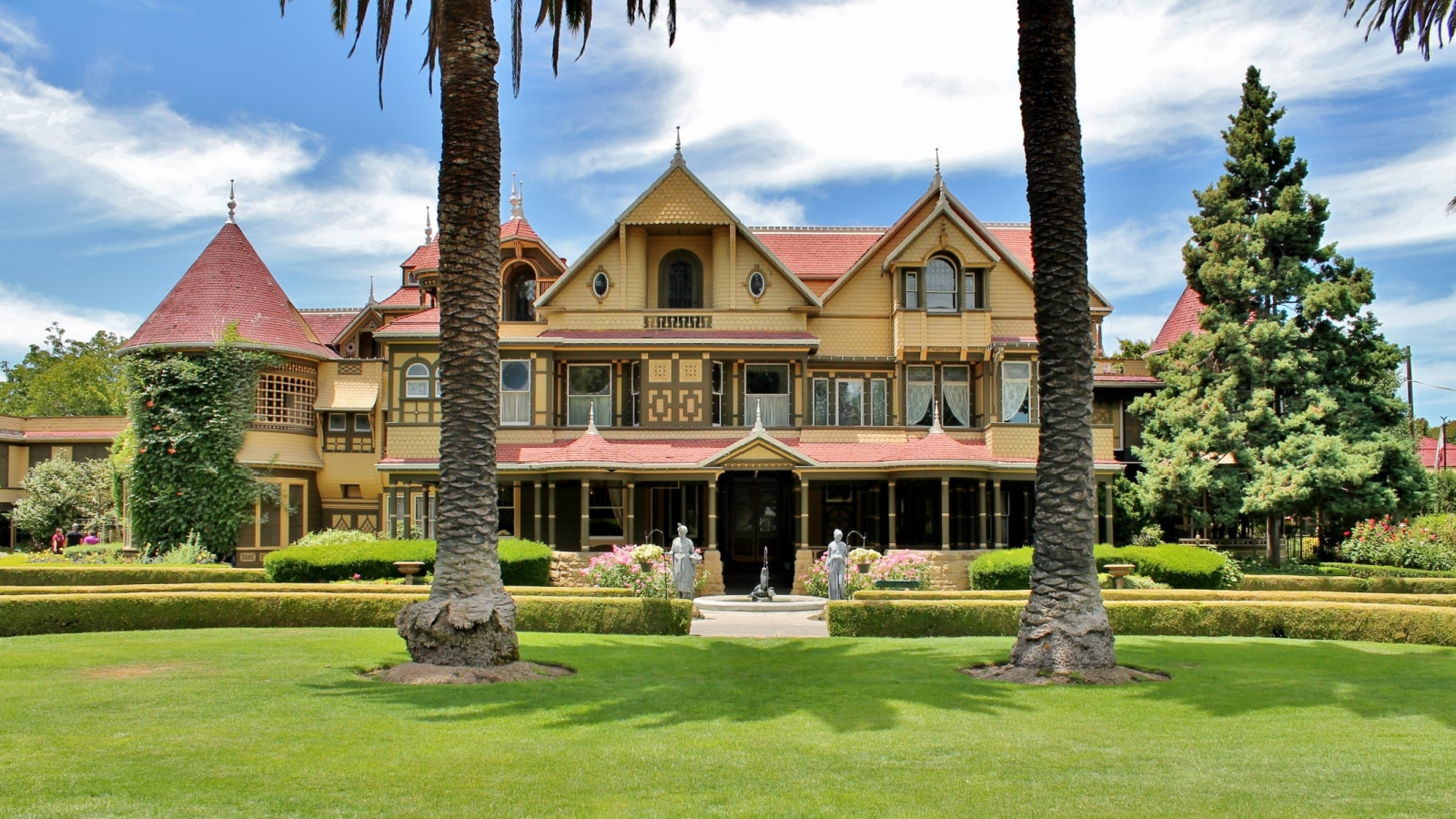 A front yard view of the Winchester Mystery House on a sunny day in San Jose California