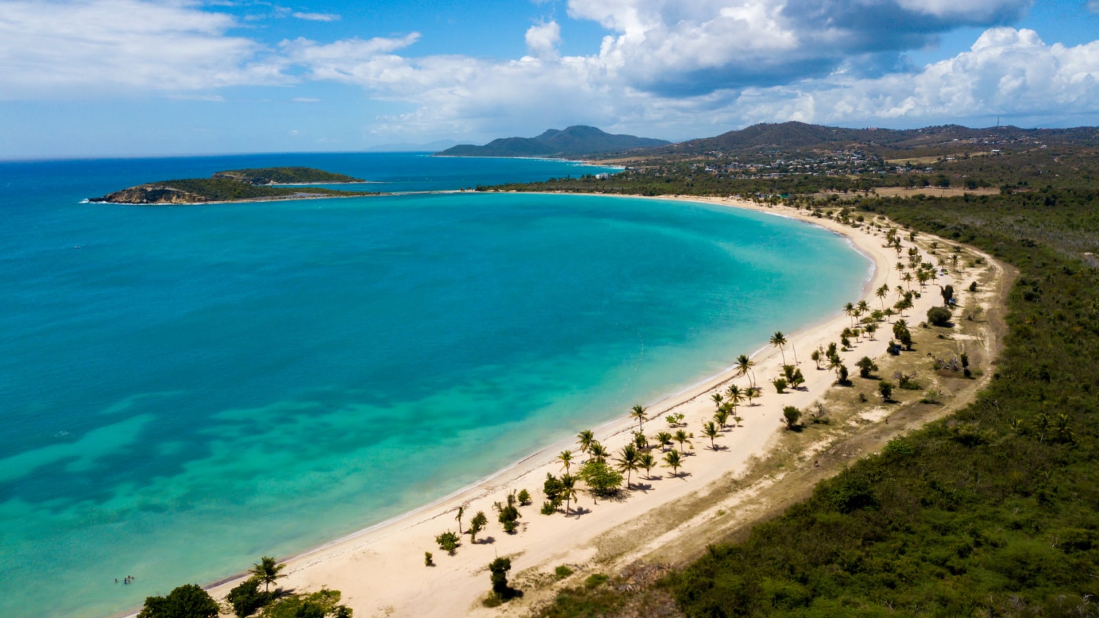 Beautiful Sun Bay beach with small fishing boats and people relaxing located on the tropical Caribbean island of Vieques Puerto Rico