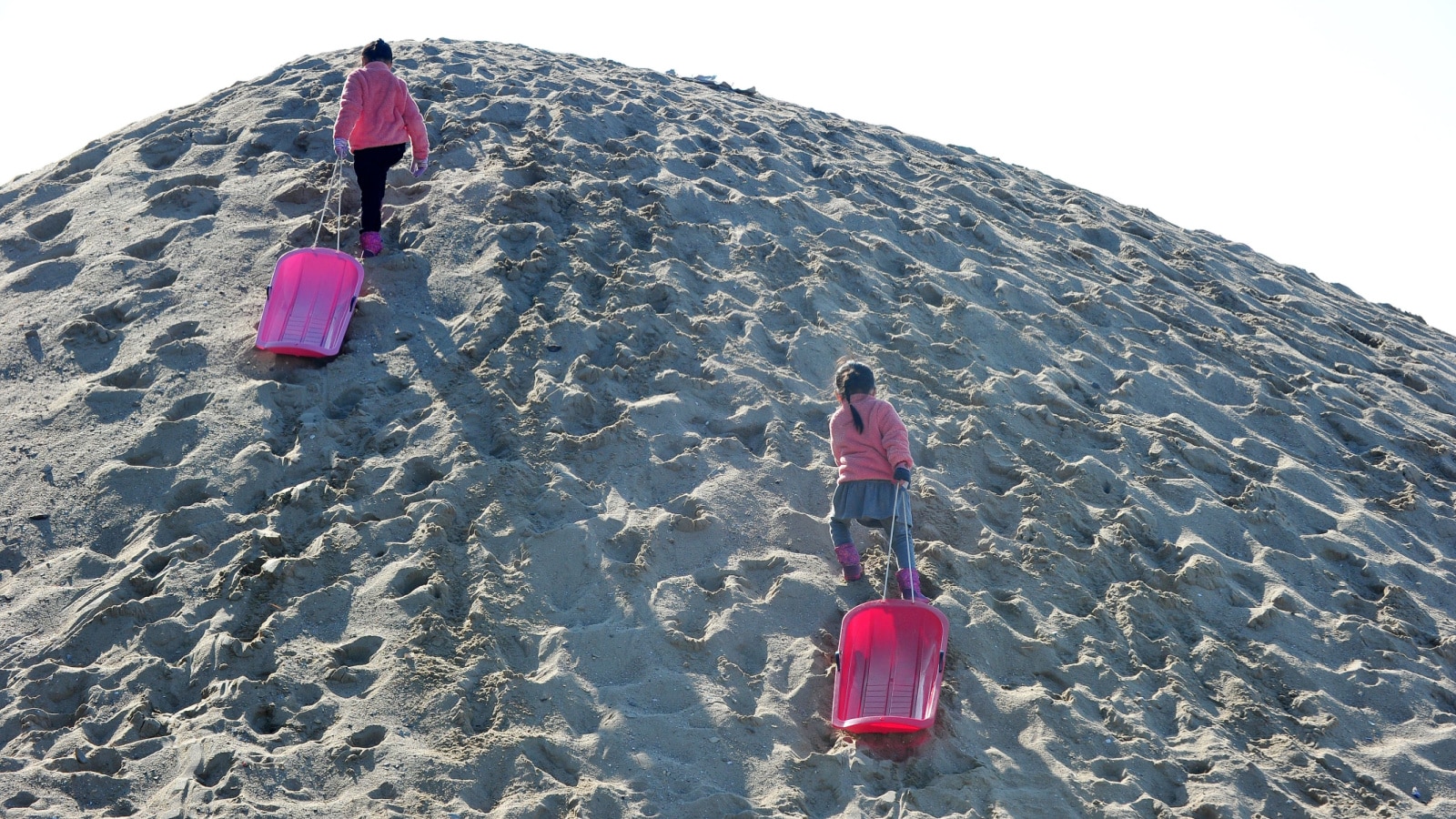 Korean Children Playing on the Sand slope.