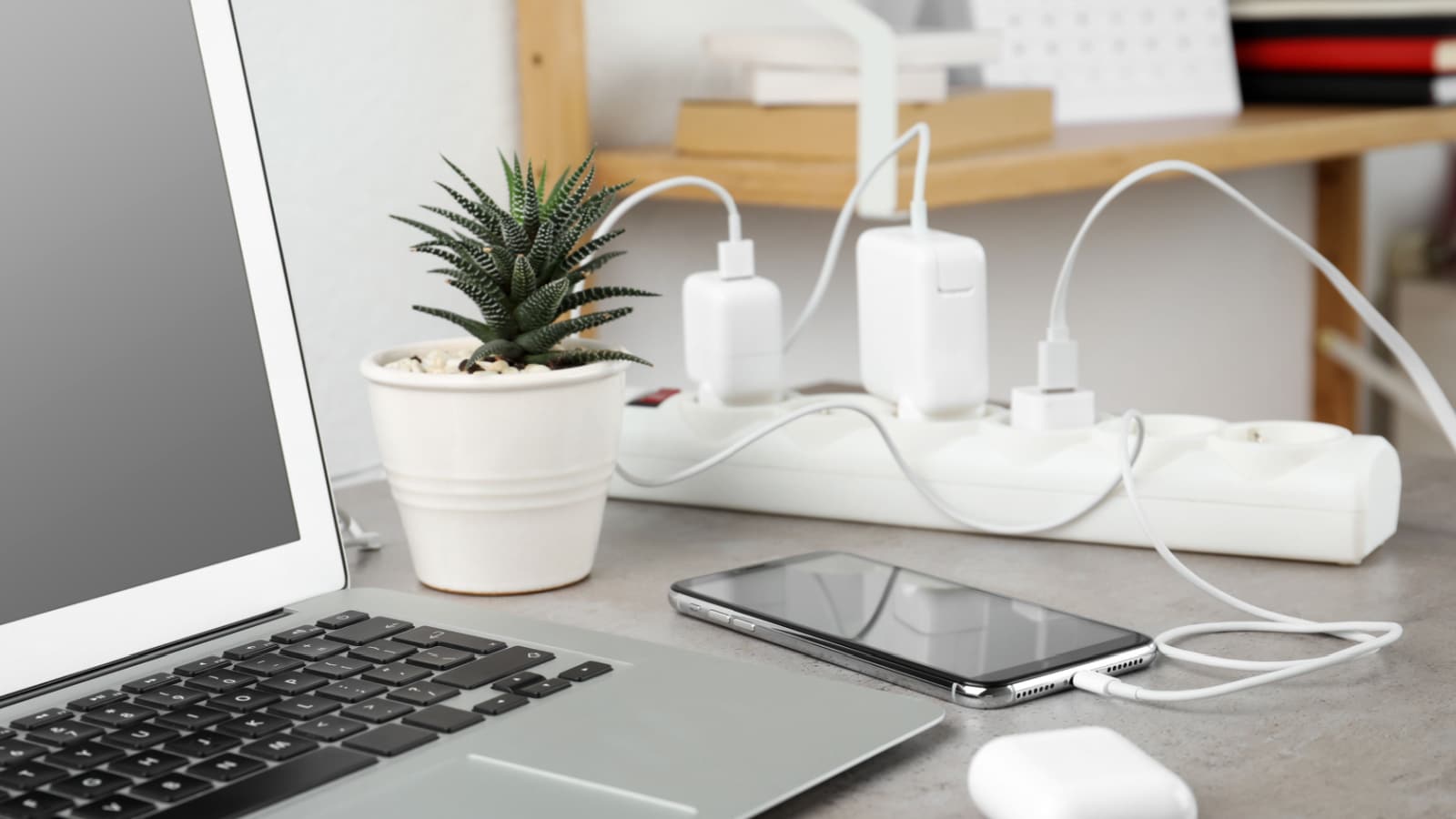 Smartphone charging with cable on light stone table