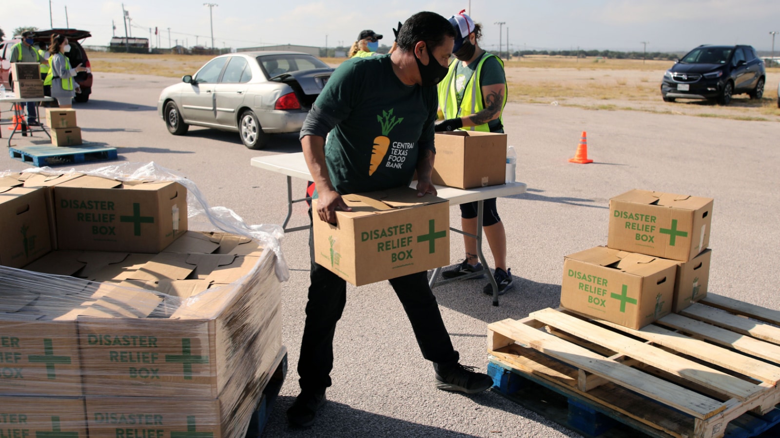 Austin, TX / USA - Nov. 19, 2020: One week before Thanksgiving, an employee of the Central Texas Food Bank transfers Disaster Relief boxes for distribution to people in need.