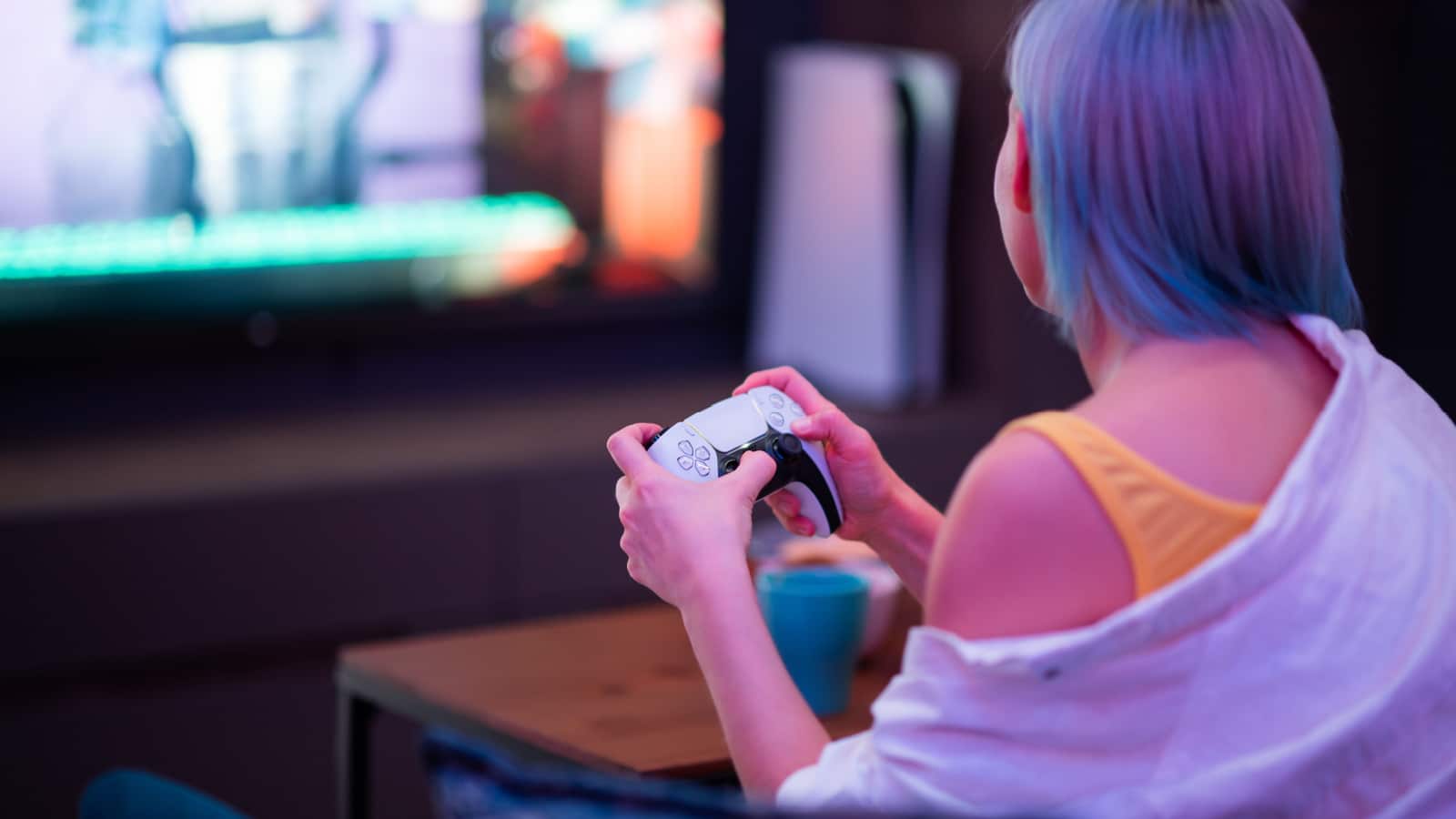 Moscow - November 28 2020: Woman holding new Dualsense controller joystick of Sony PlayStation 5 gaming console at home. Playing games with her boyfriend.