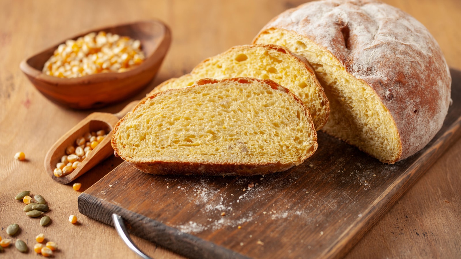 Fresh cornbread and corn grains on the table. Food grain crisis concept