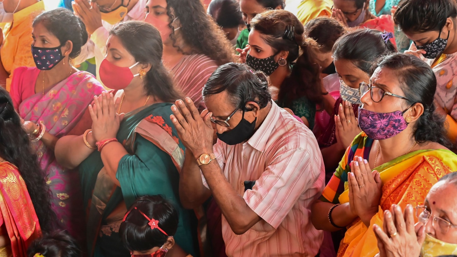 Howrah, West Bengal, India - 14th October 2021 : Hindu devotees offering pushpanjali to Goddess Durga, ritual to worship the Goddess with flowers.