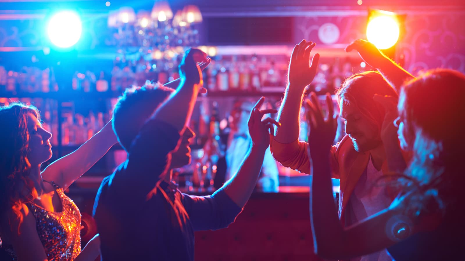 Portrait of happy friends dancing at party or bar