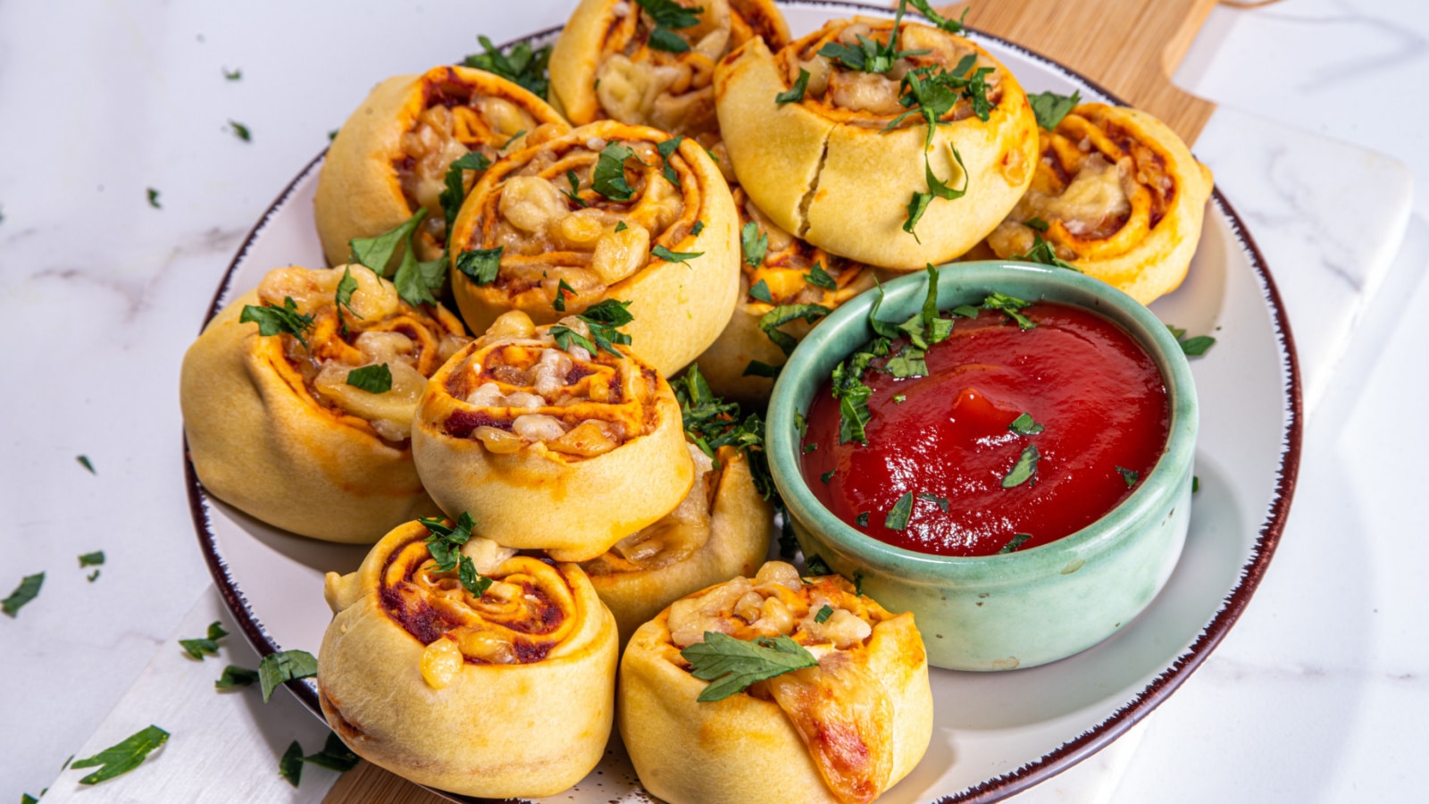 Homemade twisted Pizza rolls with tomato sauce, tomato, and cheese, trendy finger food eating pizza bites