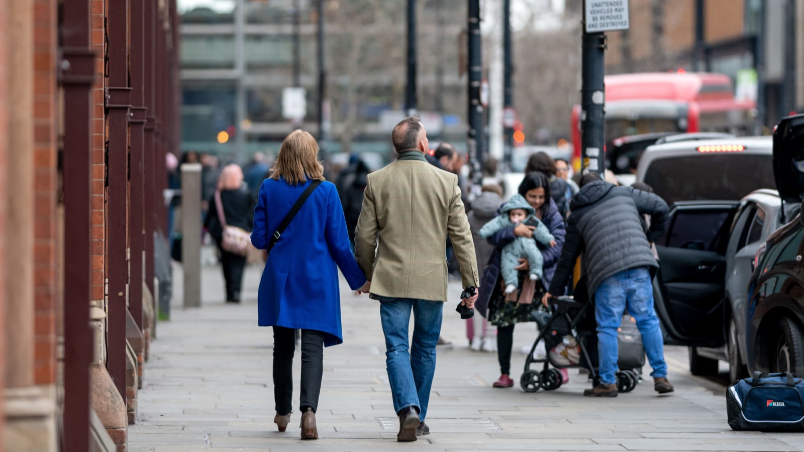London, UK - March 12, 2023: People walking outside the King's Cross underground station in London.