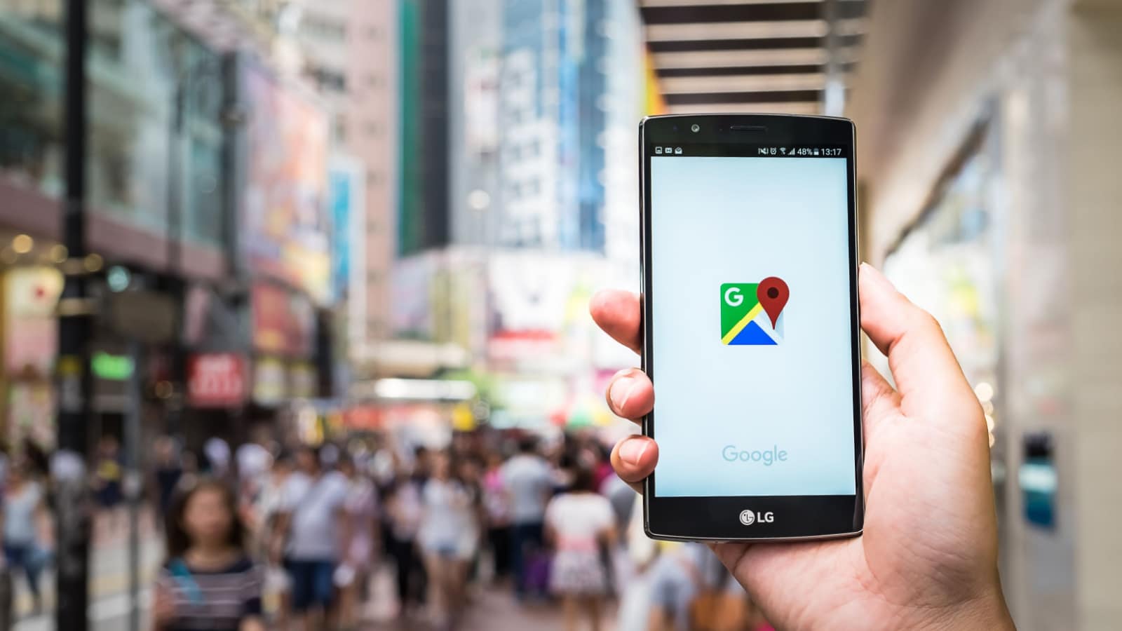 HONG KONG, CHINA - 15 MAY 2016: A man hand holding screen shot of google maps app showing on LG G4. Google Maps is most popular mapping service for mobile provided by Google.