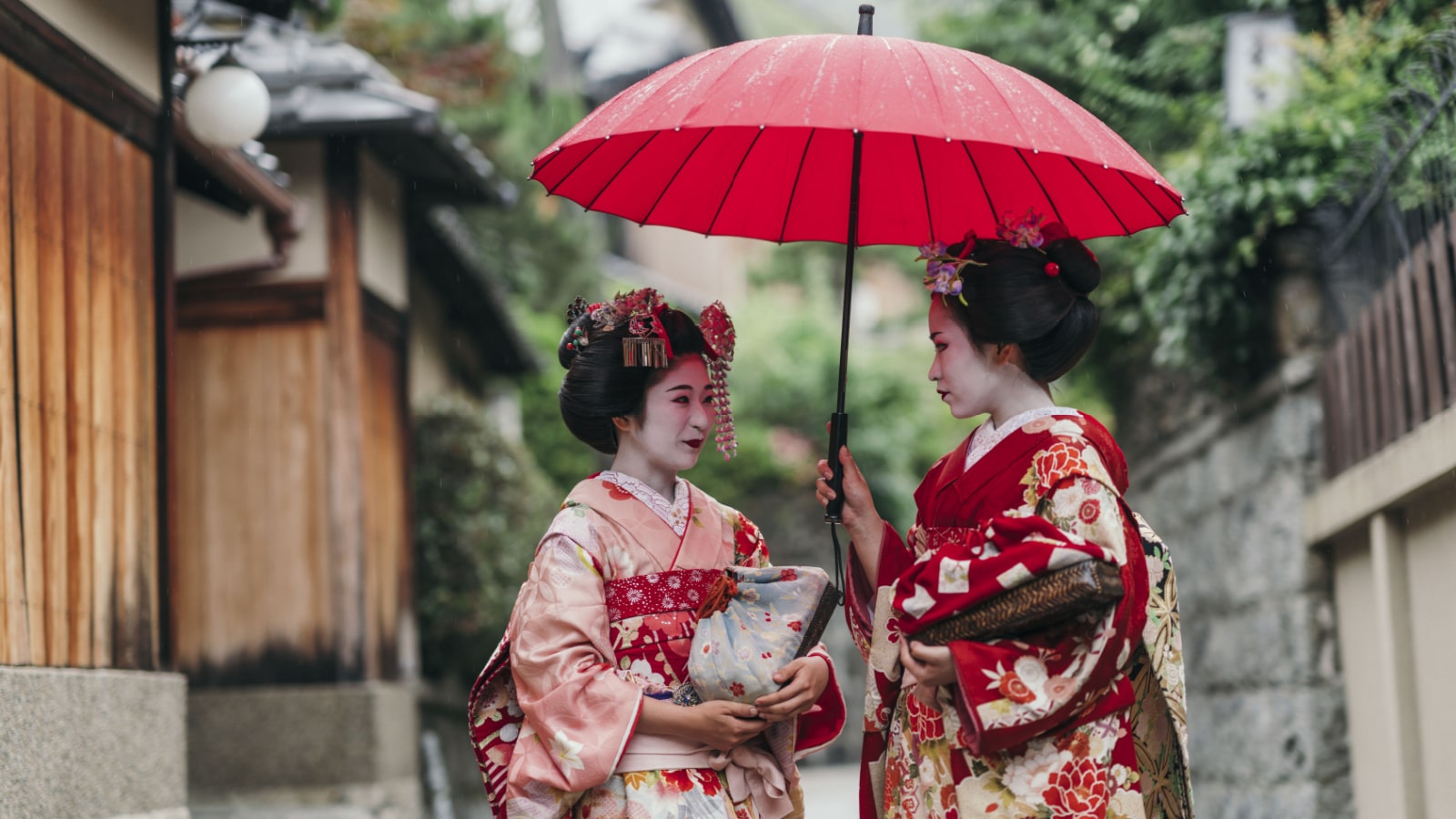 Maiko geisha walking on a street of Gion in Kyoto Japan