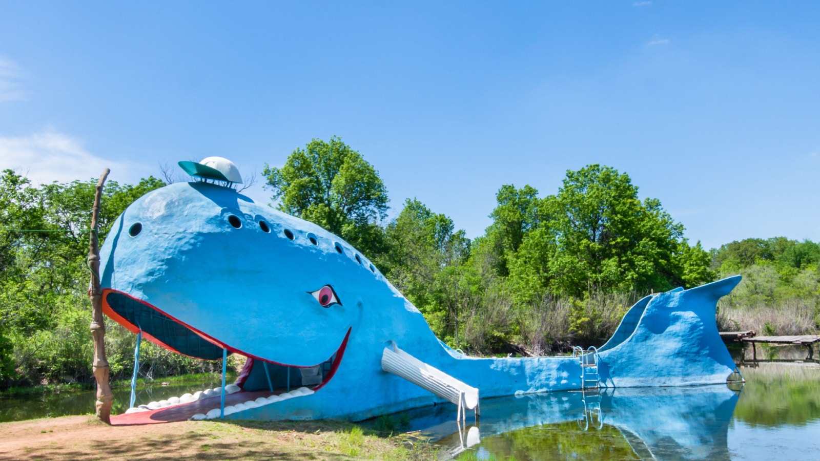 CATOOSA, OK/USA - MAY 7, 2013: Iconic Blue Whale floating in "Natures Acres" pond, on Route 66. Builder: Hugh Davis