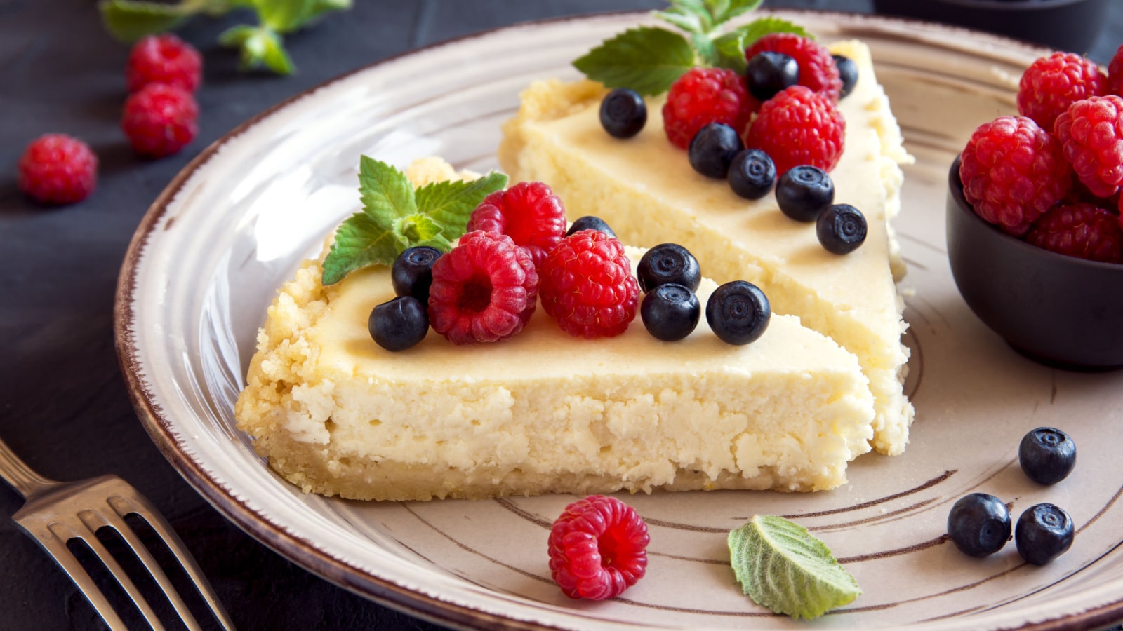 Homemade cheesecake with fresh berries and mint for dessert - healthy organic summer dessert pie cheesecake. Cheese cake.