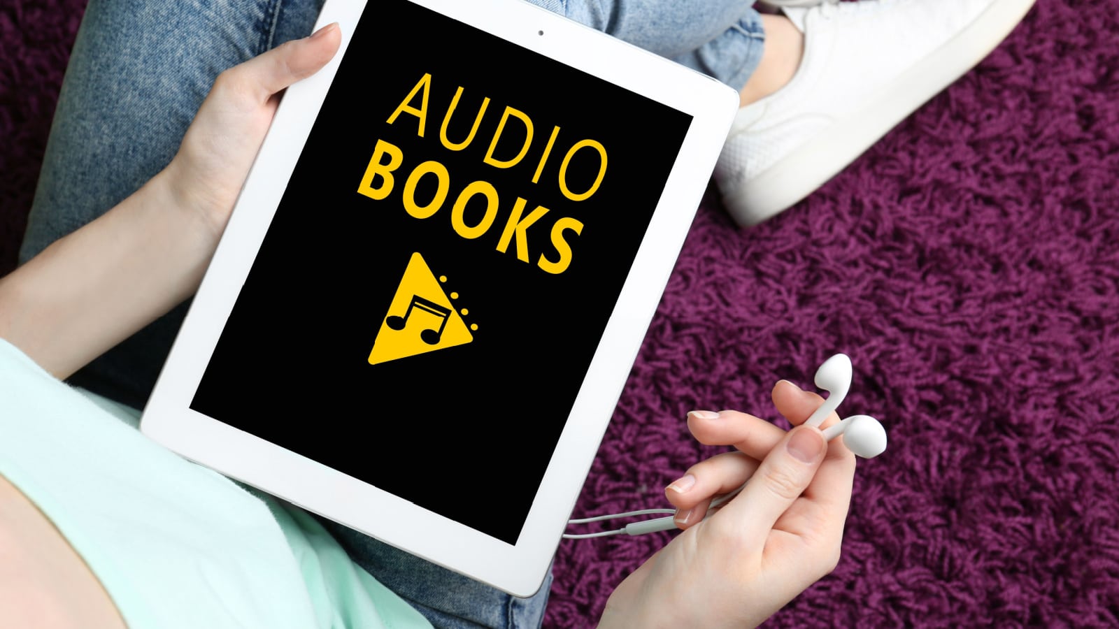 Concept of audio books and modern technology. Woman using tablet and earphones, closeup
