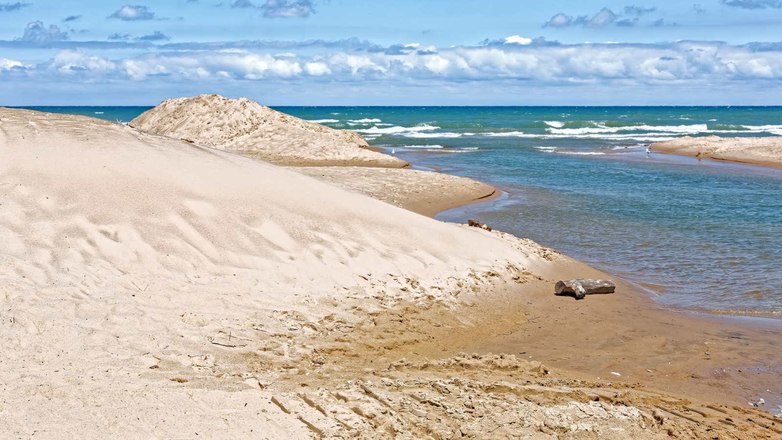 Indiana Dunes National Lakeshore is a National Park on Lake Michigan's south shore. The sand dunes make this beach a popular tourist attraction in Indiana, USA.