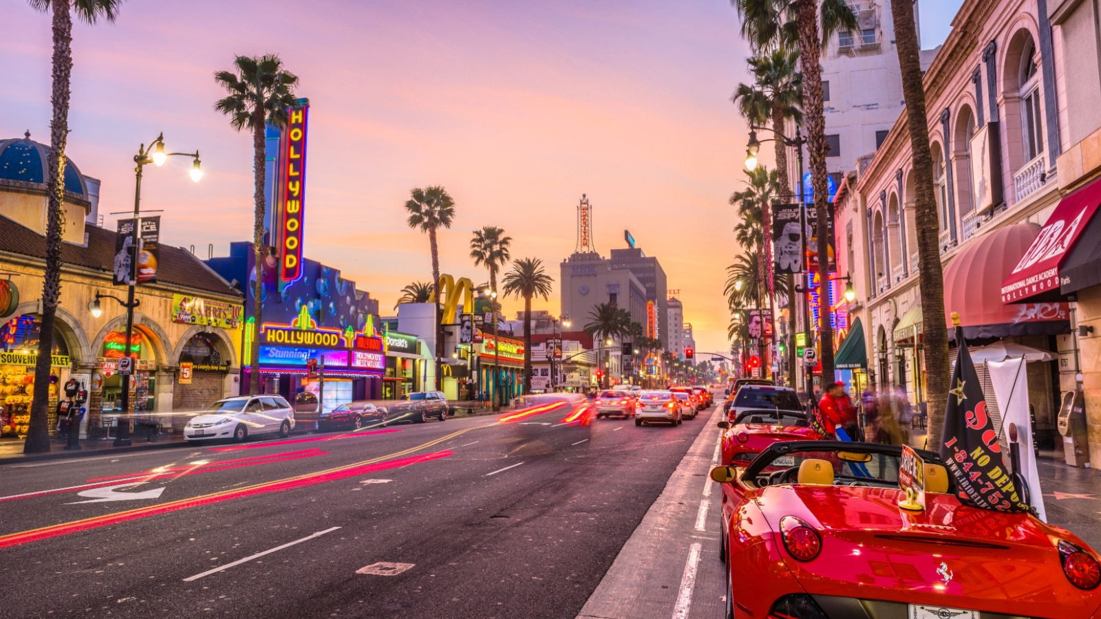 LOS ANGELES, CALIFORNIA - MARCH 1, 2016: Traffic on Hollywood Boulevard at dusk. The theater district is a famous tourist attraction.