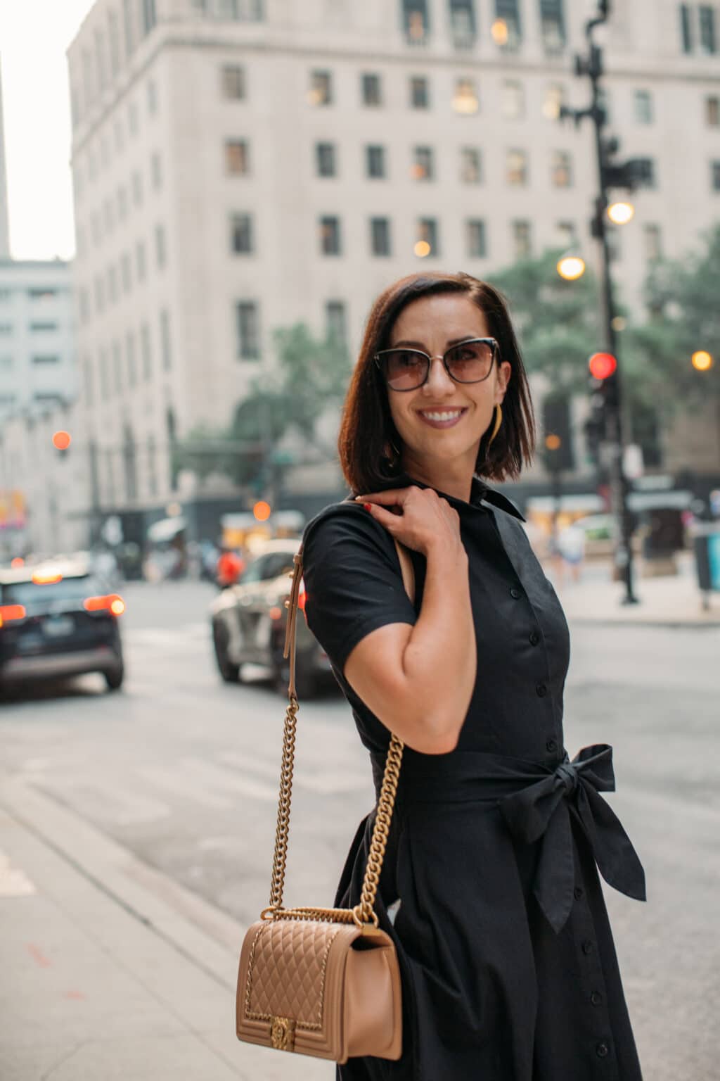 Close up of Lindsey of Have Clothes, Will Travel wearing Frances Valentine black Bella Dress standing on the street in Chicago 