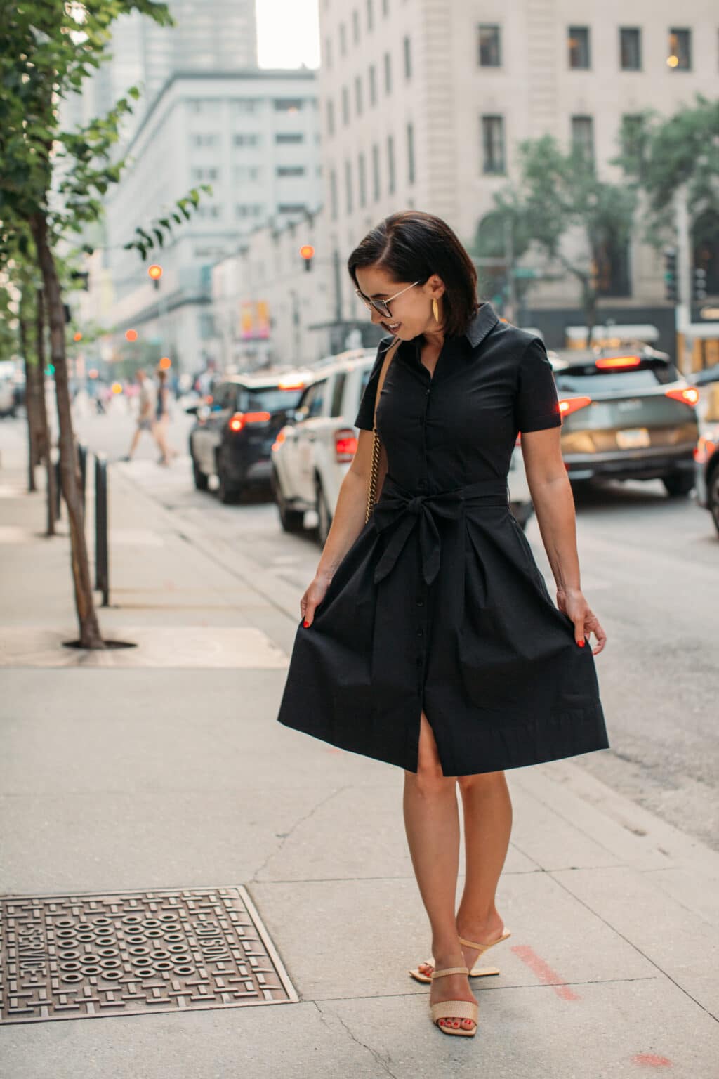 Lindsey of Have Clothes, Will Travel wearing Frances Valentine black Bella Dress standing on the street in Chicago with one hand in pocket