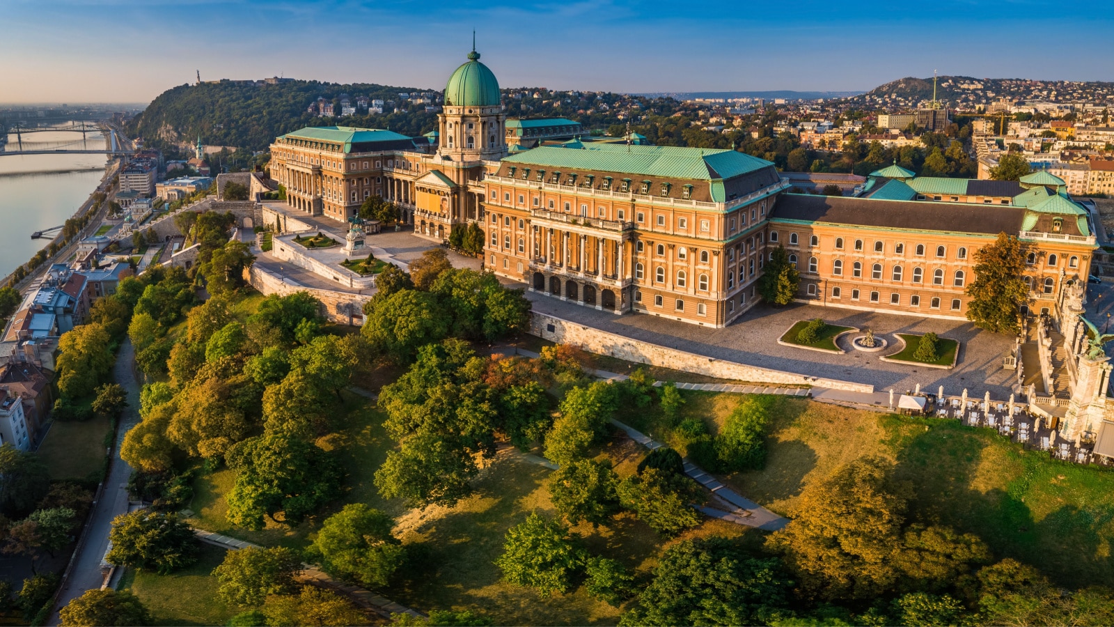 Budapest, Hungary - Aerial panoramic view of the beautiful Buda Castle Royal Palace at sunrise with Gellert Hill and Statue of Liberty at background
