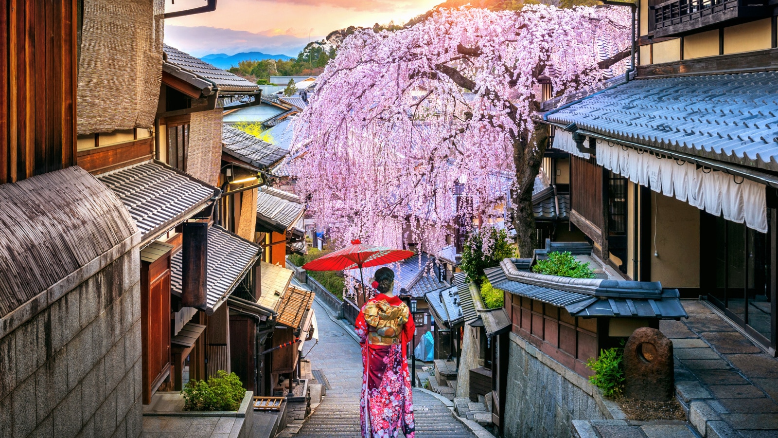 Woman wearing japanese traditional kimono walking at Historic Higashiyama district in spring, Kyoto in Japan.